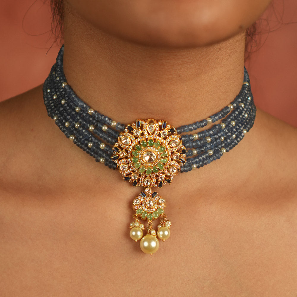 Regal elegance reimagined! This layered beaded choker, adorned with a round pendant of polki, CZ stones, and pearls, echoes timeless grandeur.