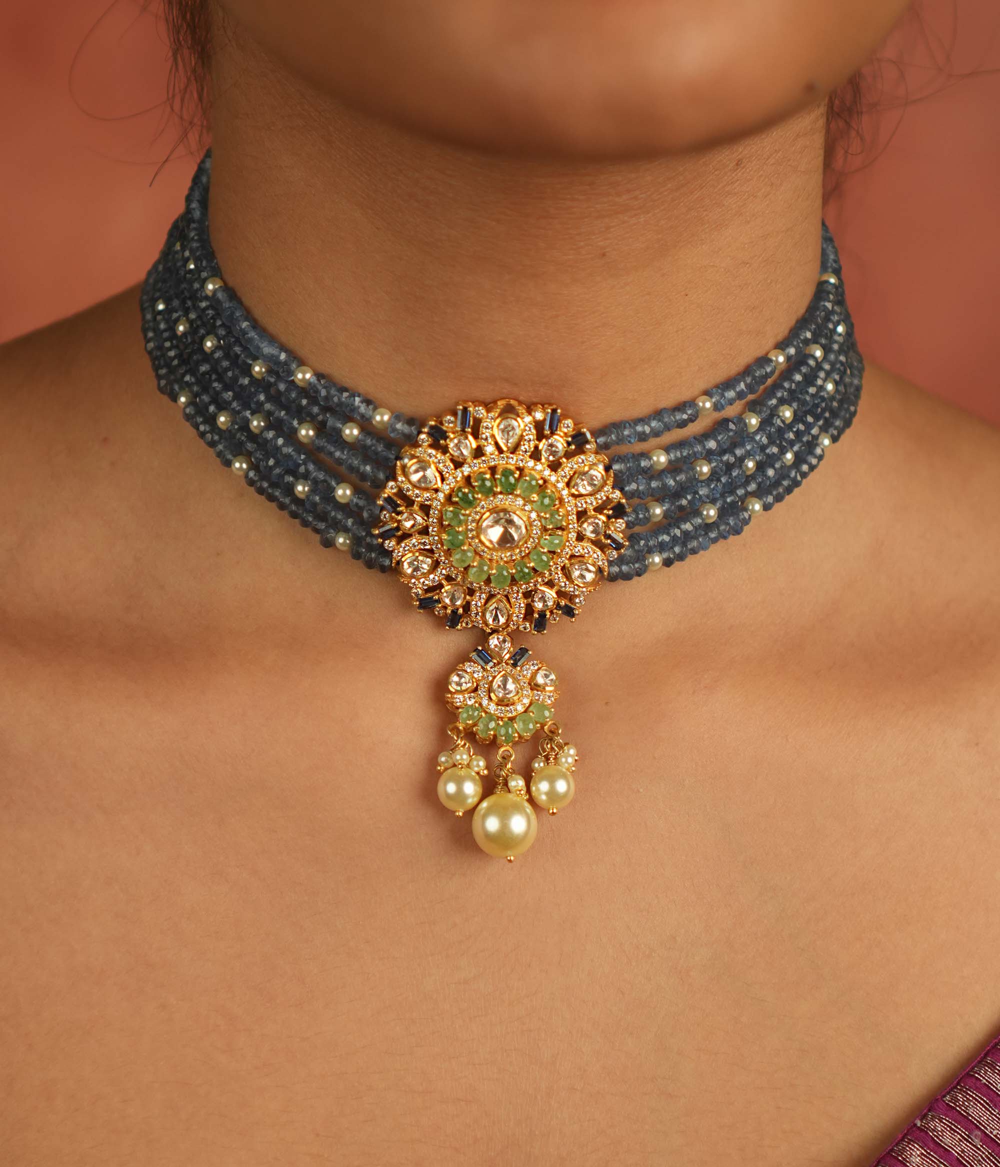 Regal elegance reimagined! This layered beaded choker, adorned with a round pendant of polki, CZ stones, and pearls, echoes timeless grandeur.