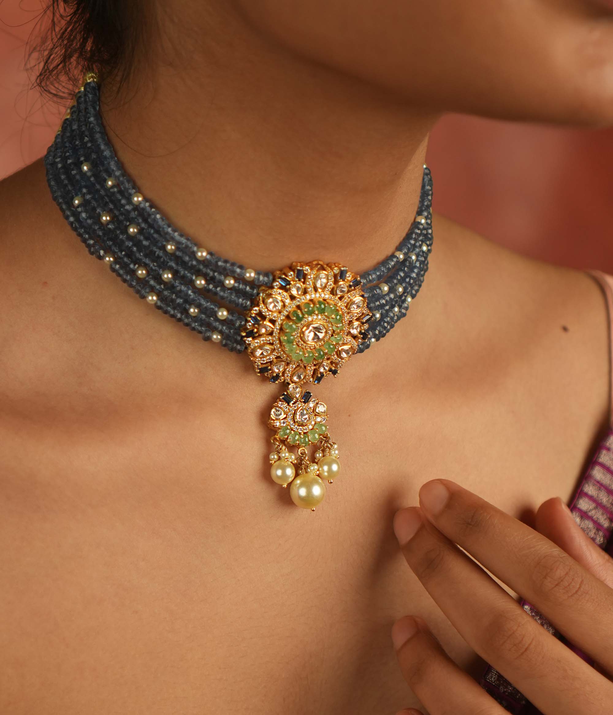 Regal elegance reimagined! This layered beaded choker, adorned with a round pendant of polki, CZ stones, and pearls, echoes timeless grandeur.