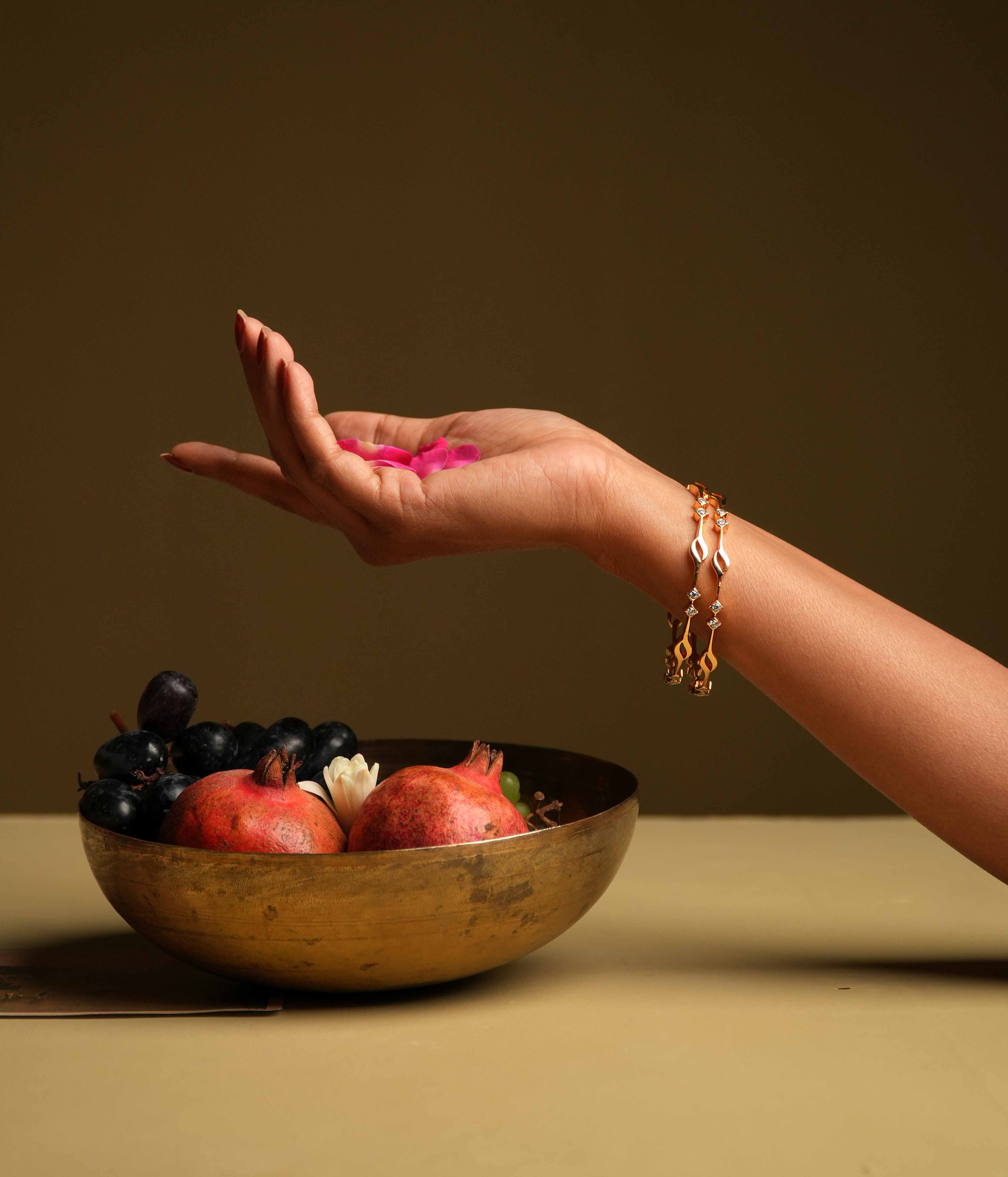 A minimalist 92.5 sterling silver bangle with an insert closure, featuring two square-cut Swarovski stones arranged at intervals, evoking the classic sophistication of traditional diamond settings.