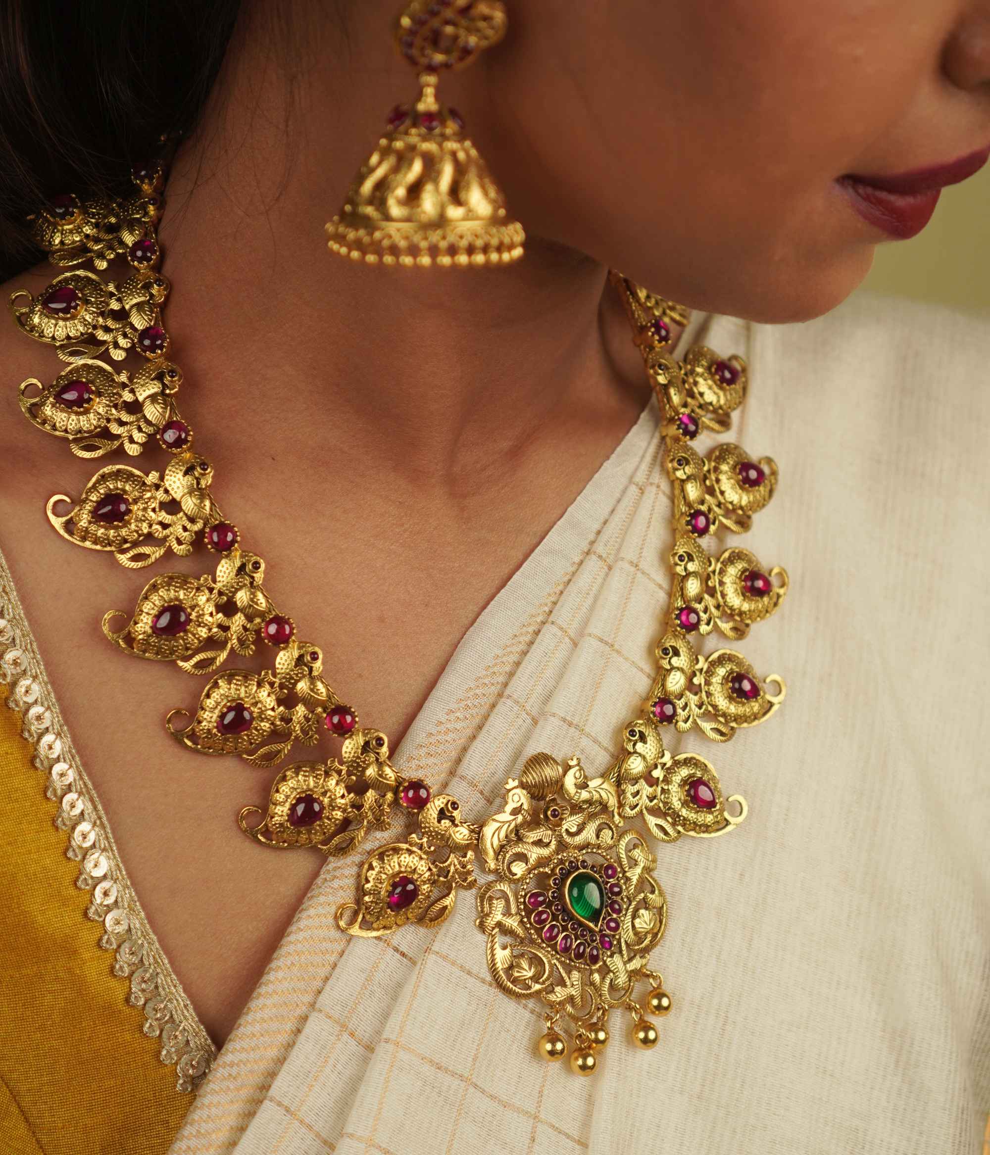 Naiyah Necklace: A tale of regality reborn. Gold-plated silver with intricate peacock motifs and vibrant spinel stones, blending timeless grace with contemporary allure.