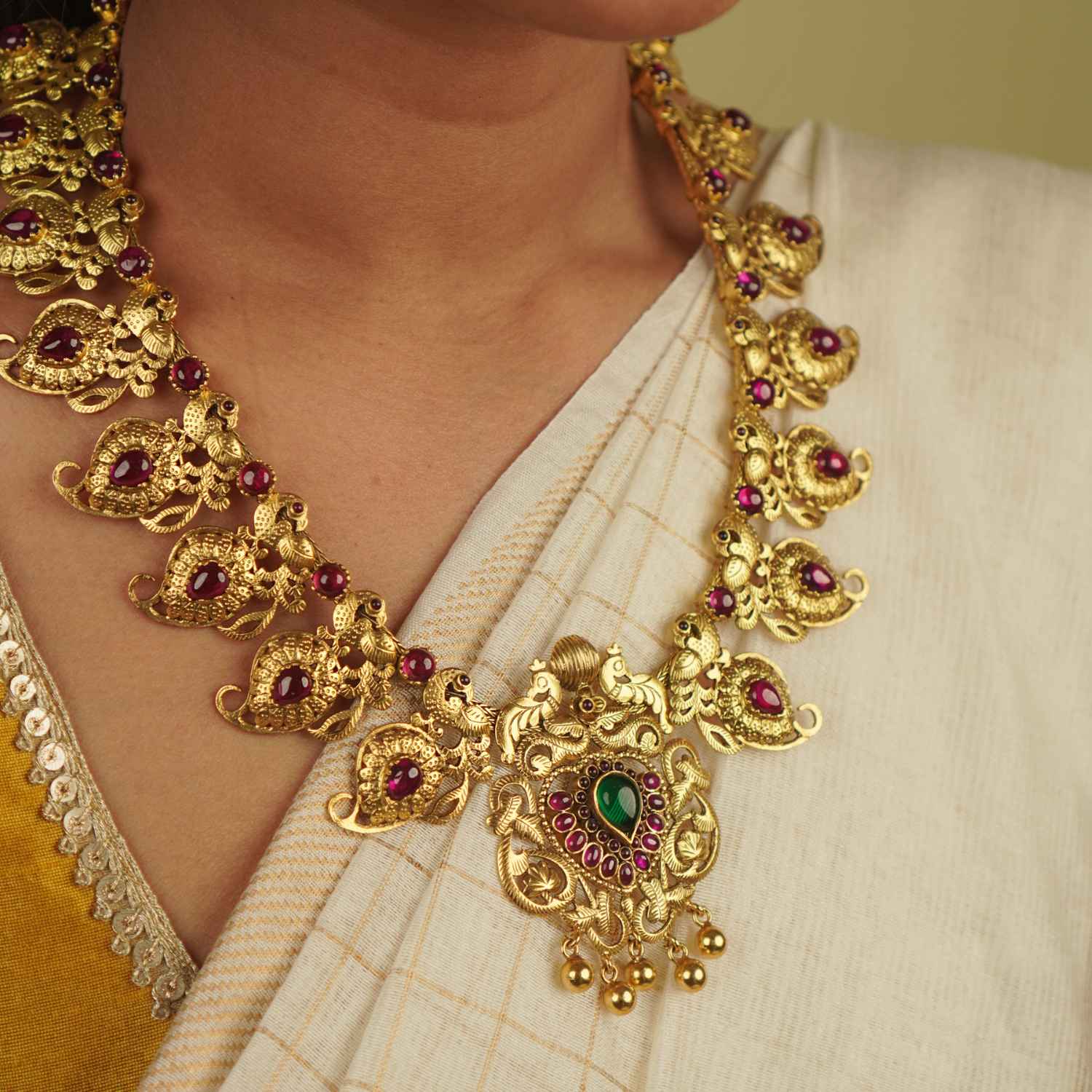 Naiyah Necklace: A tale of regality reborn. Gold-plated silver with intricate peacock motifs and vibrant spinel stones, blending timeless grace with contemporary allure.