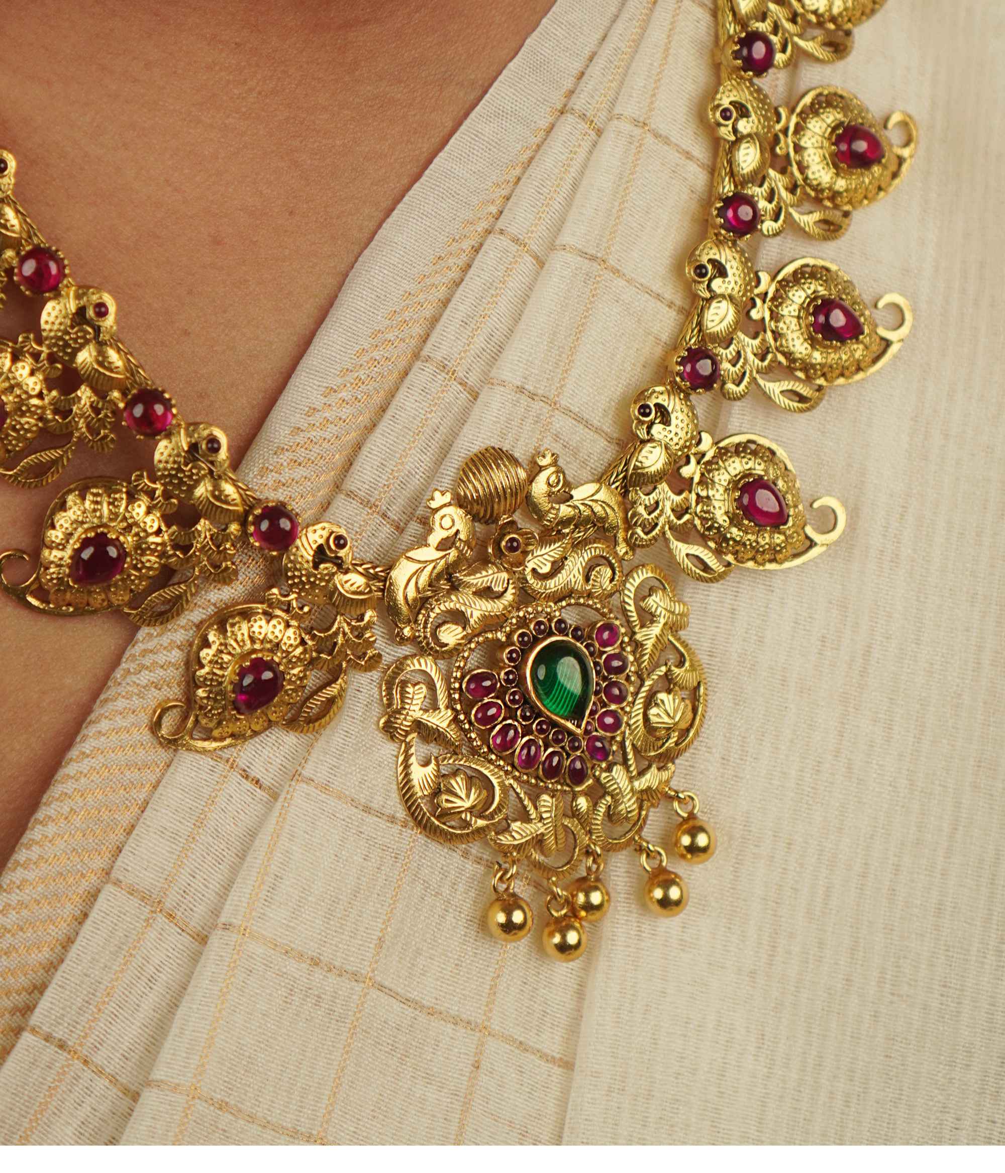 Naiyah Necklace: A tale of regality reborn. Gold-plated silver with intricate peacock motifs and vibrant spinel stones, blending timeless grace with contemporary allure.