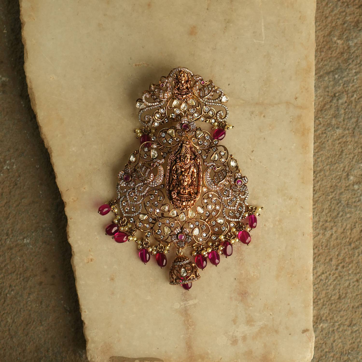 This exquisite pendant showcases the divine goddess Lakshmi, gracefully encircled by radiant Polki and Moissanite stones, symbolizing prosperity and elegance.