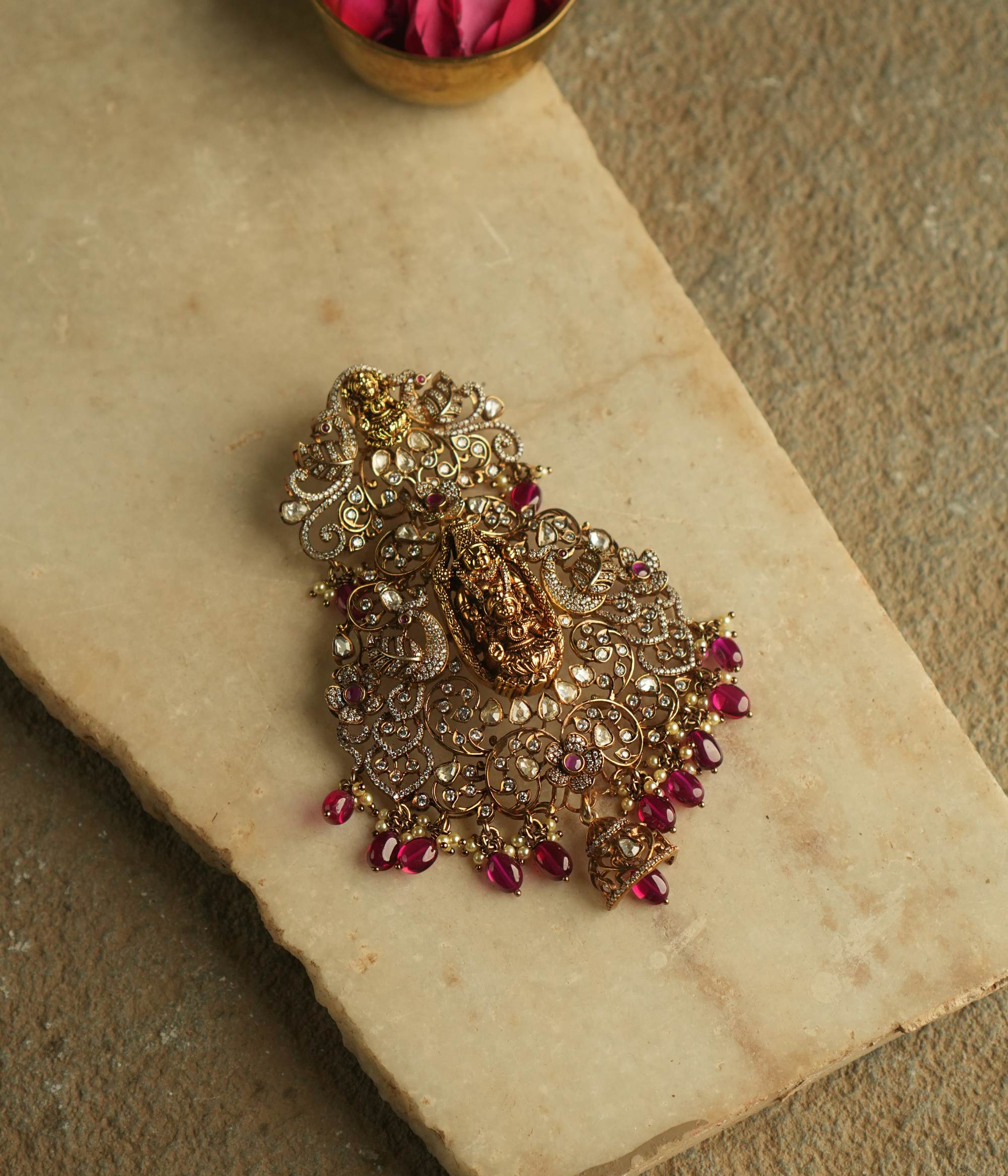 This exquisite pendant showcases the divine goddess Lakshmi, gracefully encircled by radiant Polki and Moissanite stones, symbolizing prosperity and elegance.