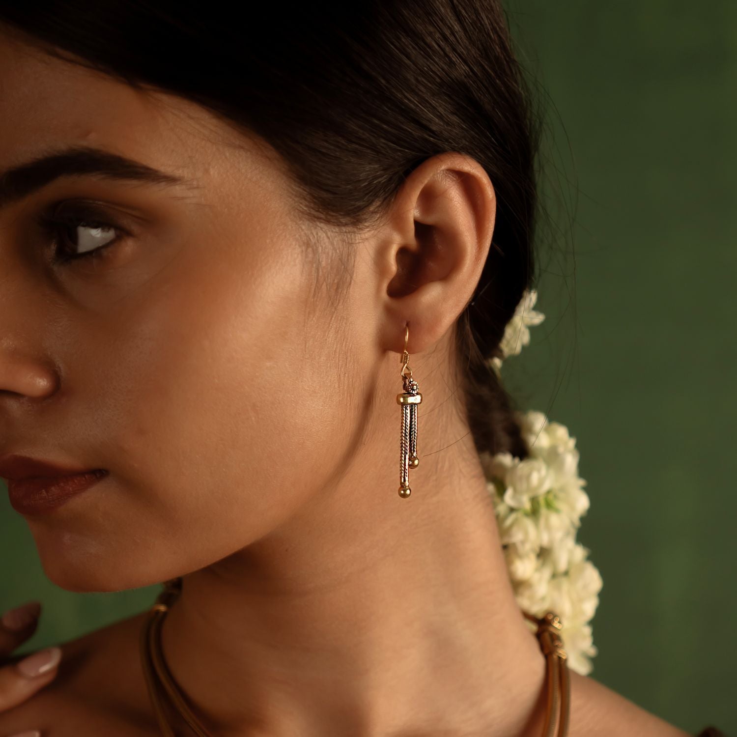 The Nimai Earrings effortlessly blend simplicity with sophistication. Each dangling element tells a story of timeless elegance, capturing the essence of understated beauty.
