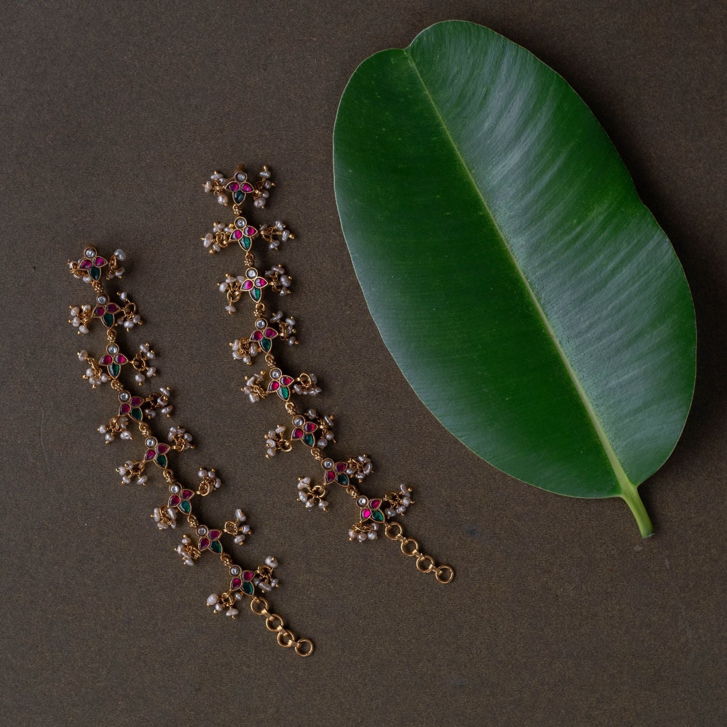 Kundan elegance handcrafted into heirloom ear chains, timeless beauty and cultural legacy intertwined delicately.
