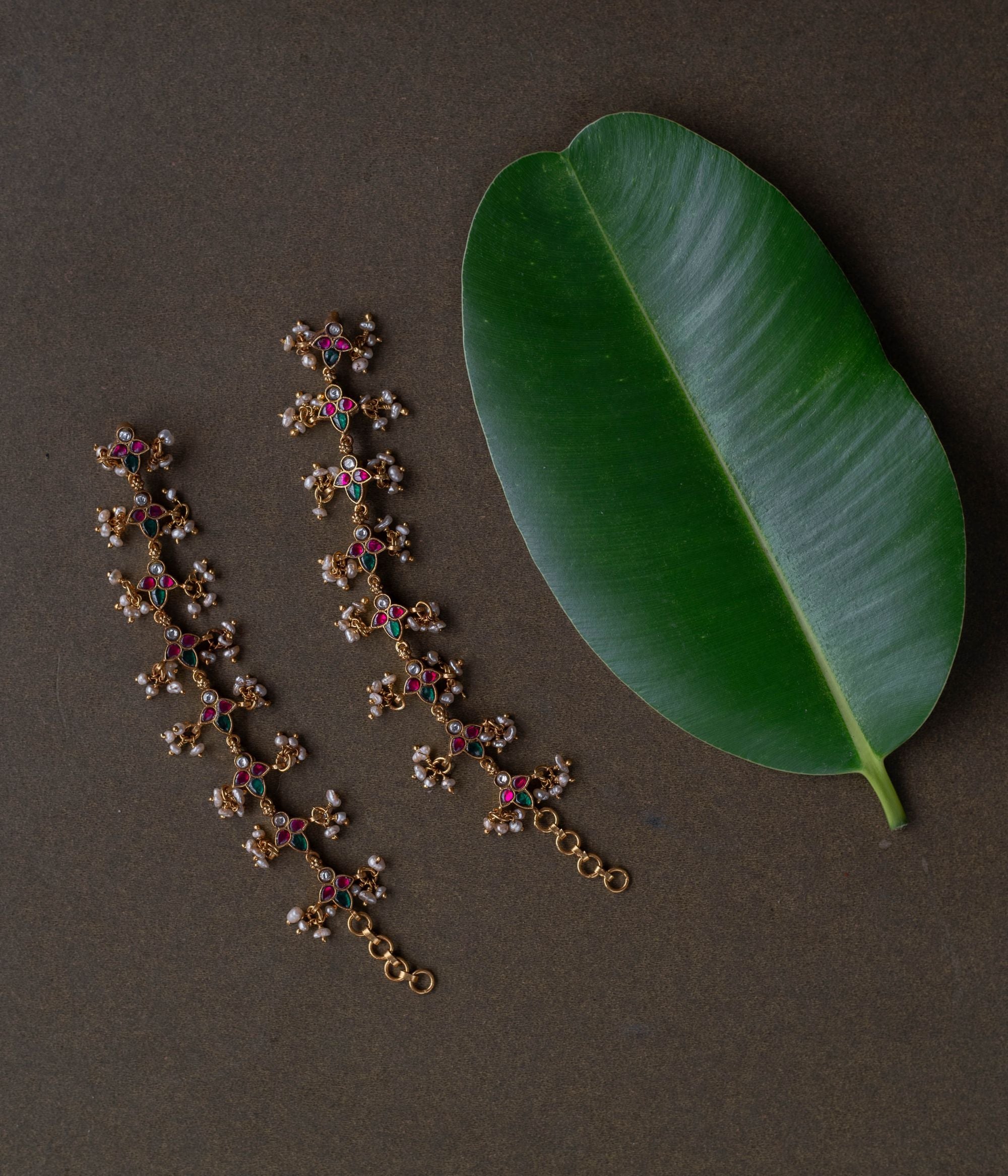 Kundan elegance handcrafted into heirloom ear chains, timeless beauty and cultural legacy intertwined delicately.