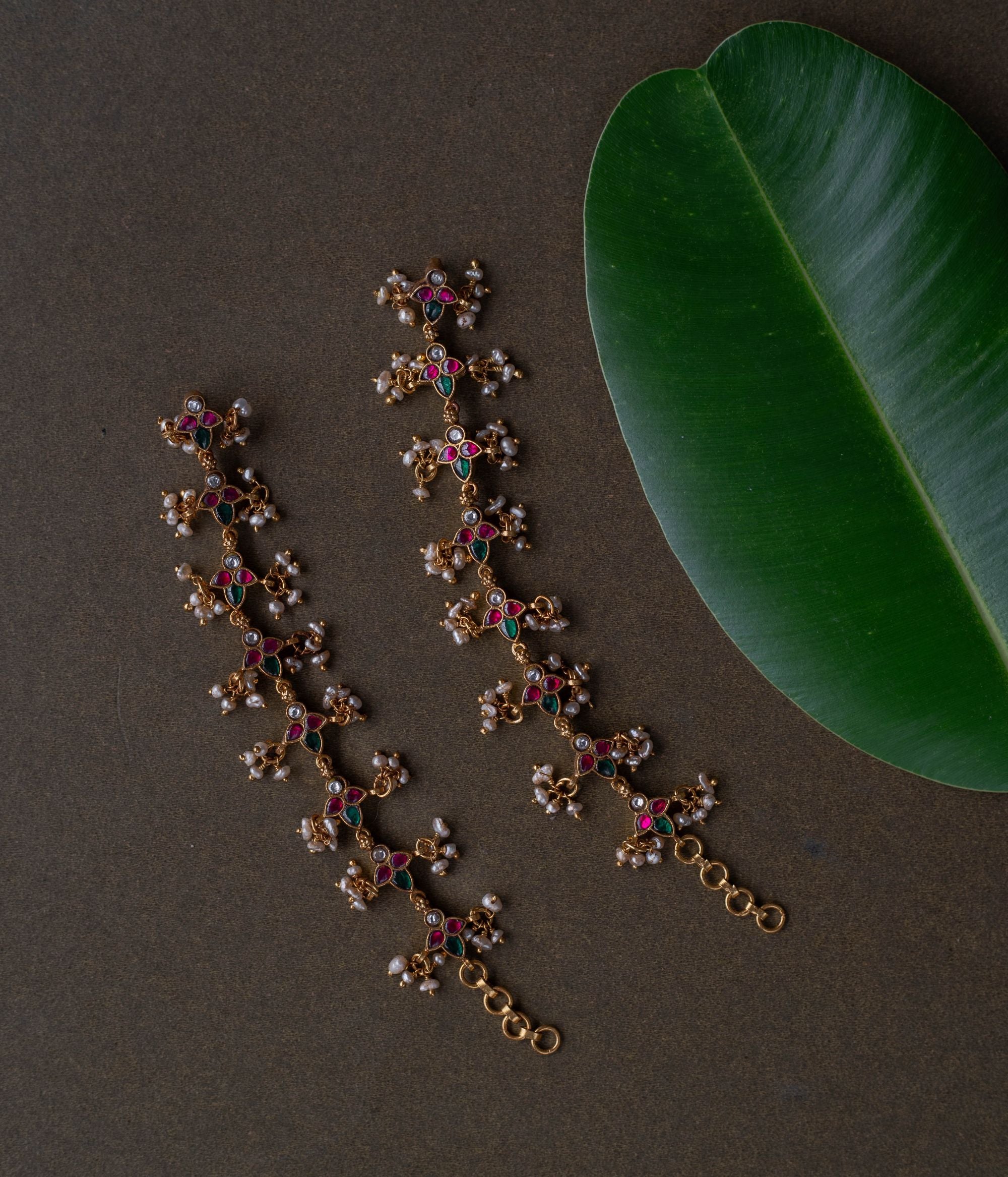 Kundan elegance handcrafted into heirloom ear chains, timeless beauty and cultural legacy intertwined delicately.
