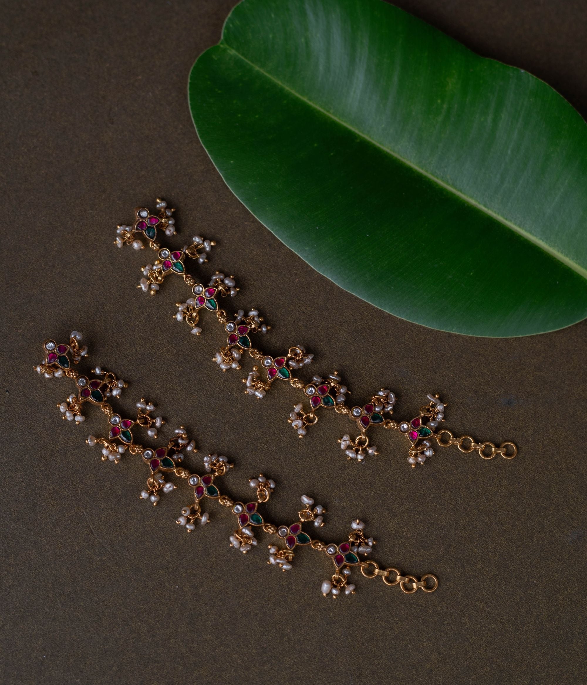 Kundan elegance handcrafted into heirloom ear chains, timeless beauty and cultural legacy intertwined delicately.