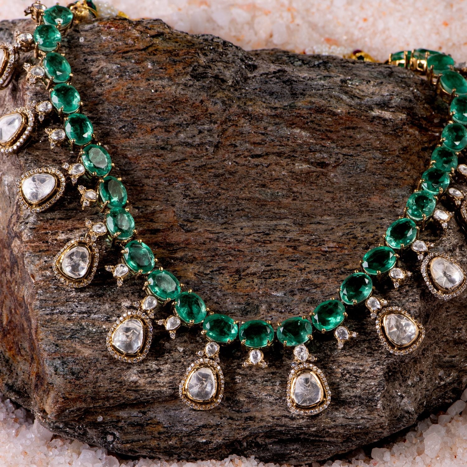 Gold-plated silver necklace featuring a continuous chain of vibrant green gemstones, elegantly adorned with Moissanite Polki stone drops, each surrounded by shimmering CZ stones. This exquisite design exudes grace and sophistication, making it a timeless statement piece.