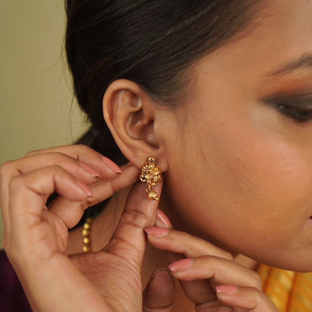 Ojal Earrings: Where tradition meets contemporary charm. Gold-plated silver with red spinel stones, blending temple artistry with modern minimalism.
