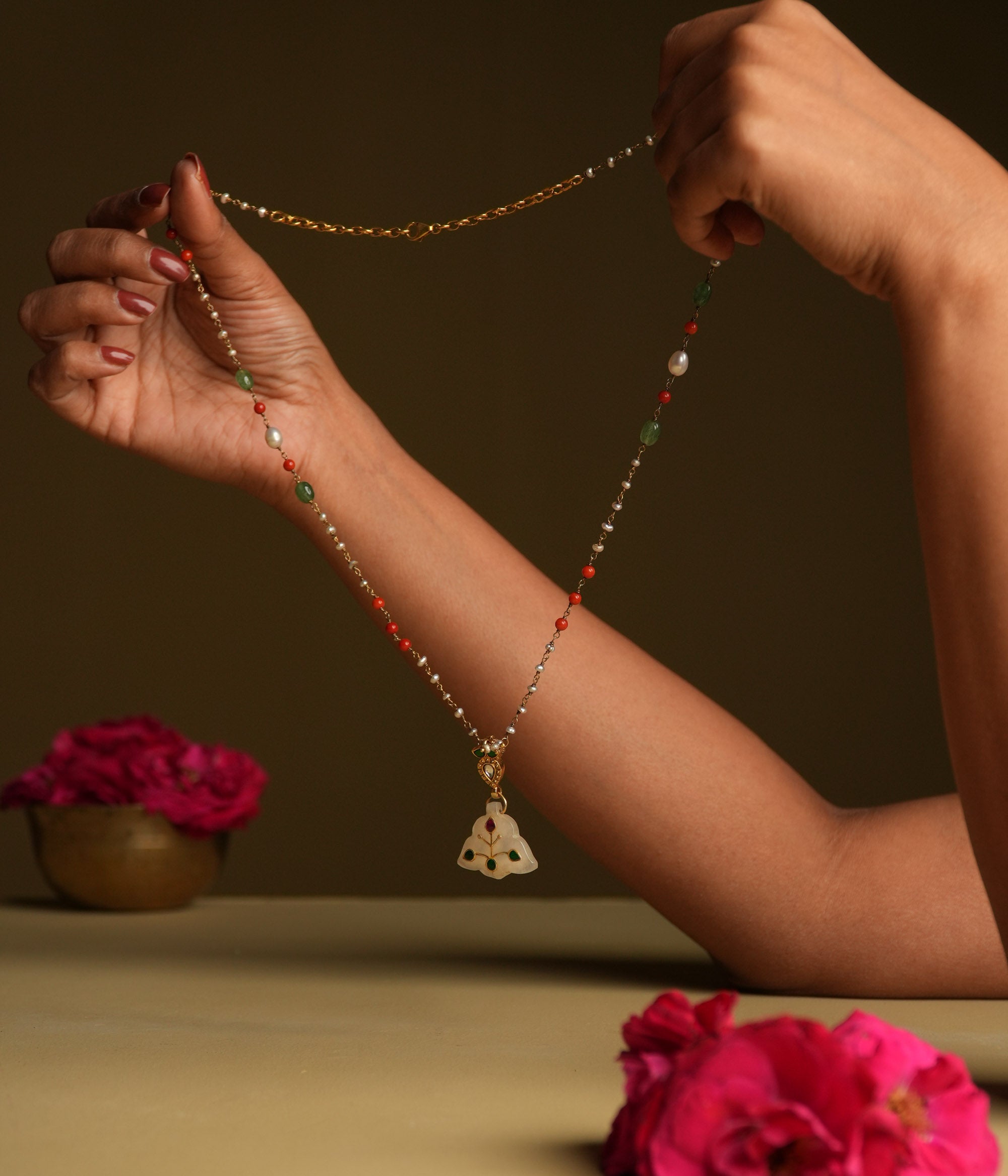 A delicate 92.5 sterling silver necklace featuring a carved white natural stone pendant with intricate meenakari engravings, inspired by Rajput techniques, embodying understated luxury and heritage elegance.