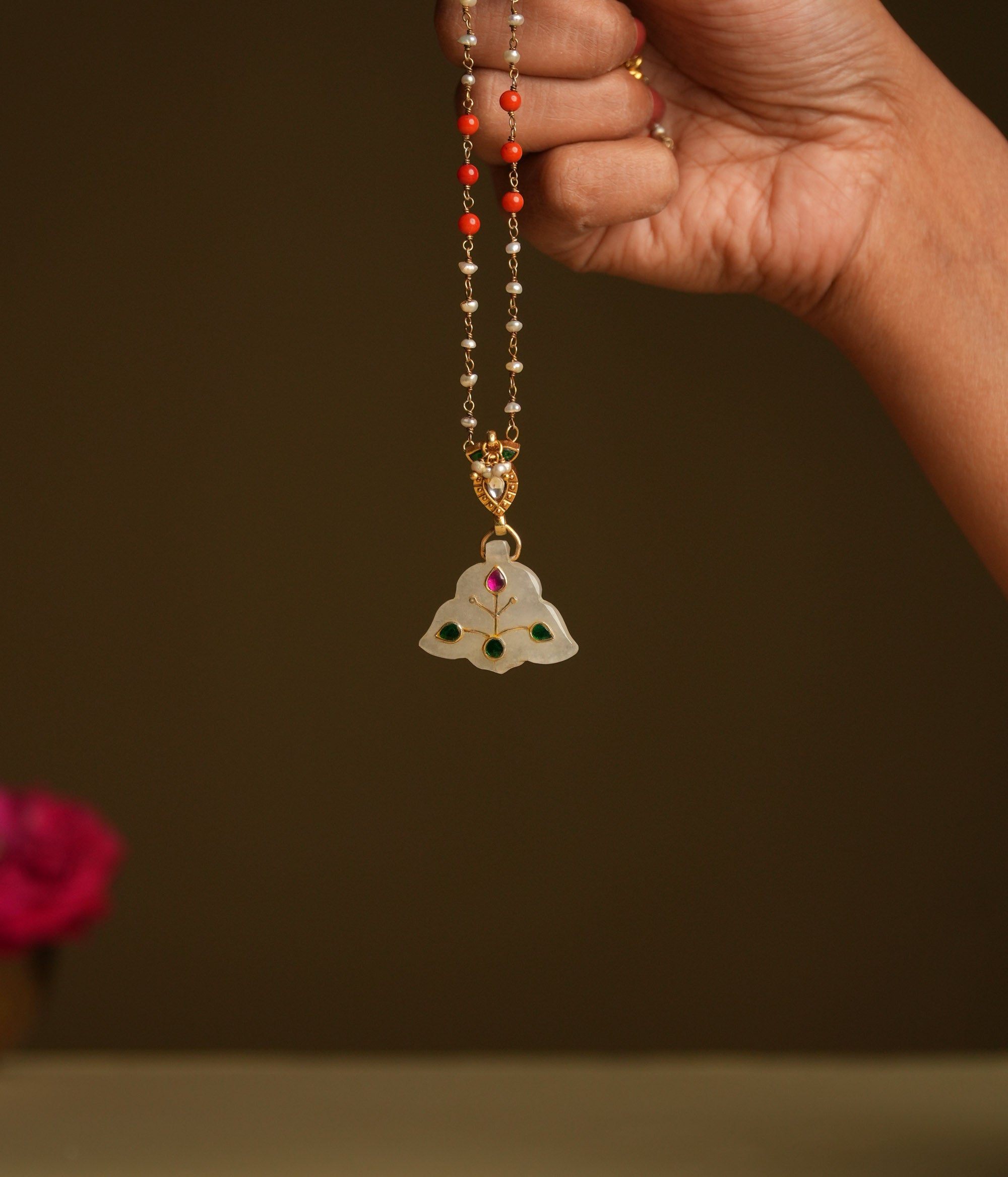 A delicate 92.5 sterling silver necklace featuring a carved white natural stone pendant with intricate meenakari engravings, inspired by Rajput techniques, embodying understated luxury and heritage elegance.