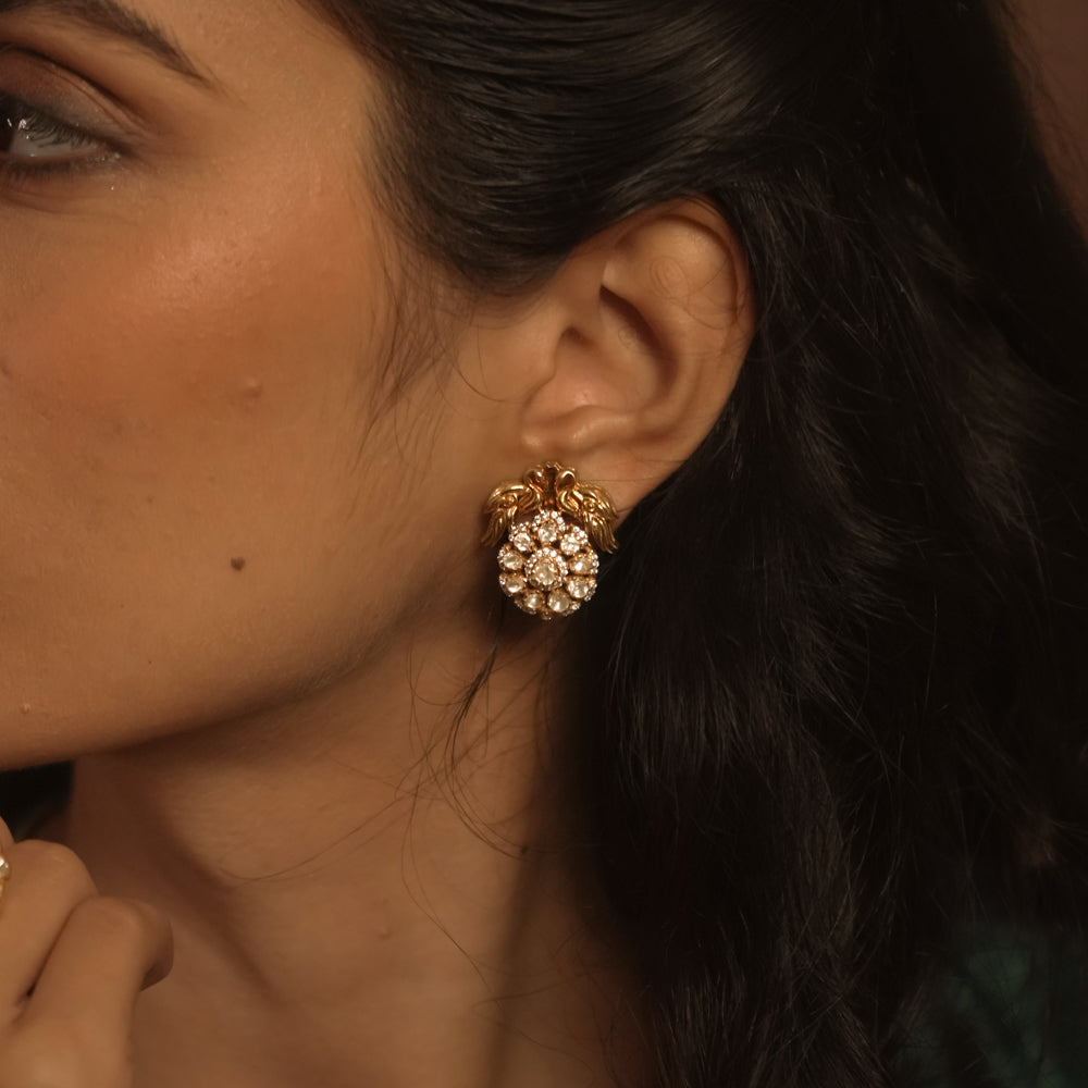 Polki stud earring with white Polki stones, CZ sparkle, and golden floral detailing.
