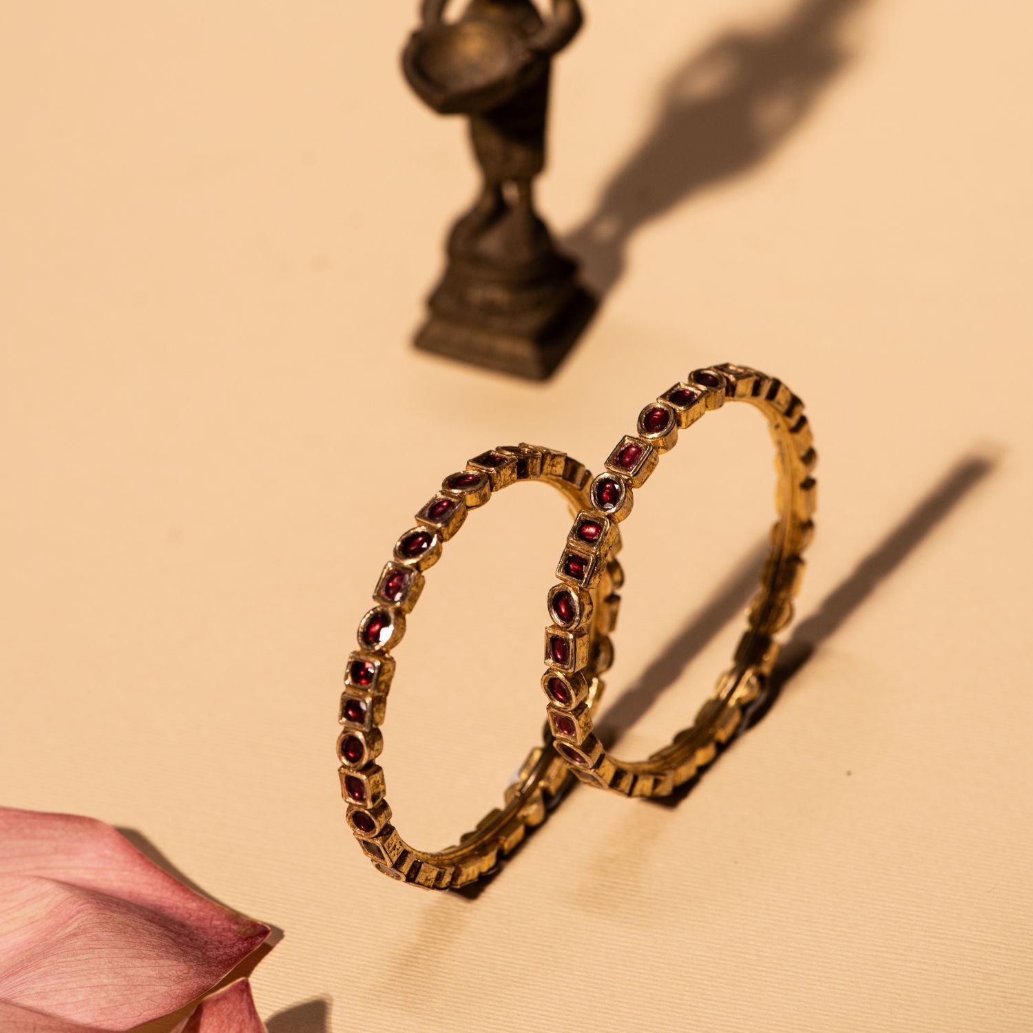 Gold-plated silver bangle featuring an elegant arrangement of circle and square-shaped rubies, creating a rich, traditional look. The intricate design adds a timeless charm, making it a perfect accessory for any cultural or festive occasion