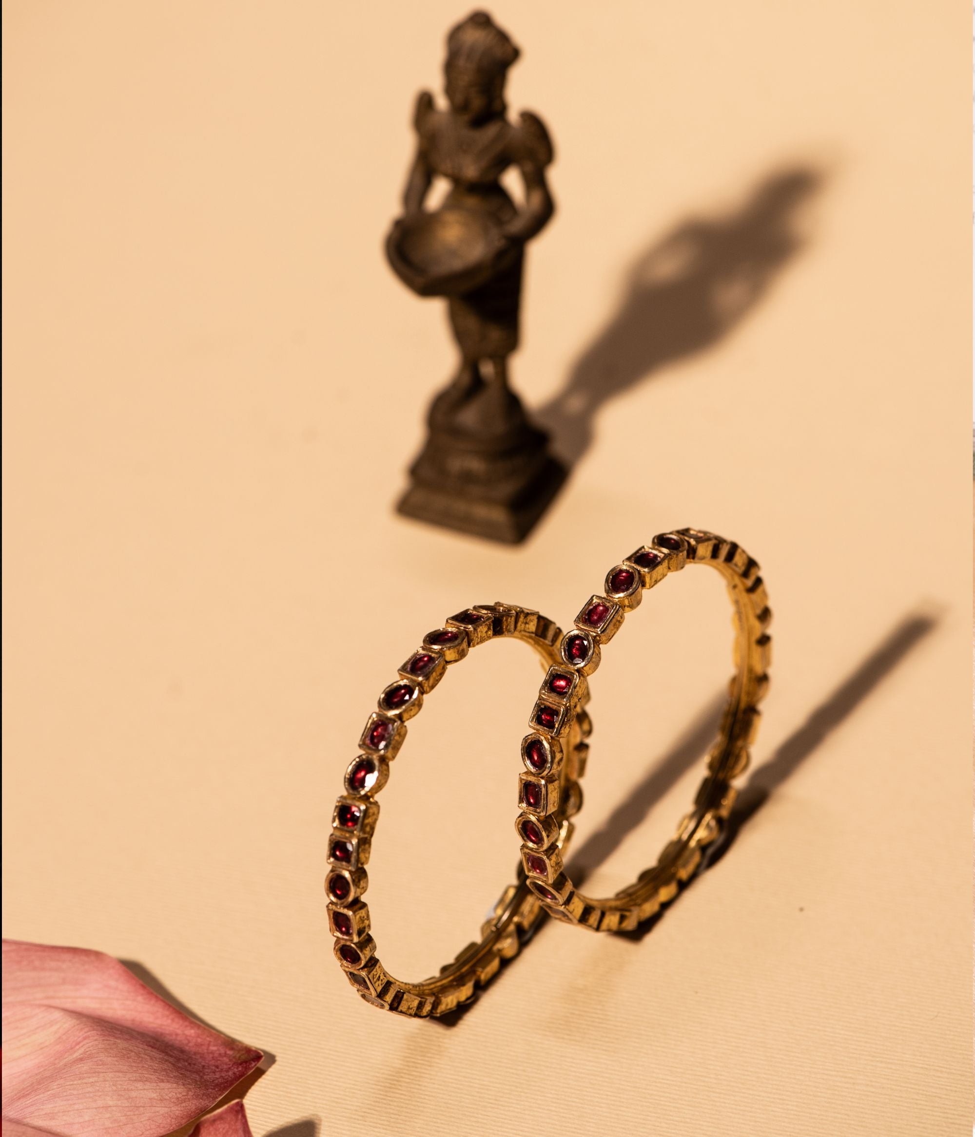 Gold-plated silver bangle featuring an elegant arrangement of circle and square-shaped rubies, creating a rich, traditional look. The intricate design adds a timeless charm, making it a perfect accessory for any cultural or festive occasion