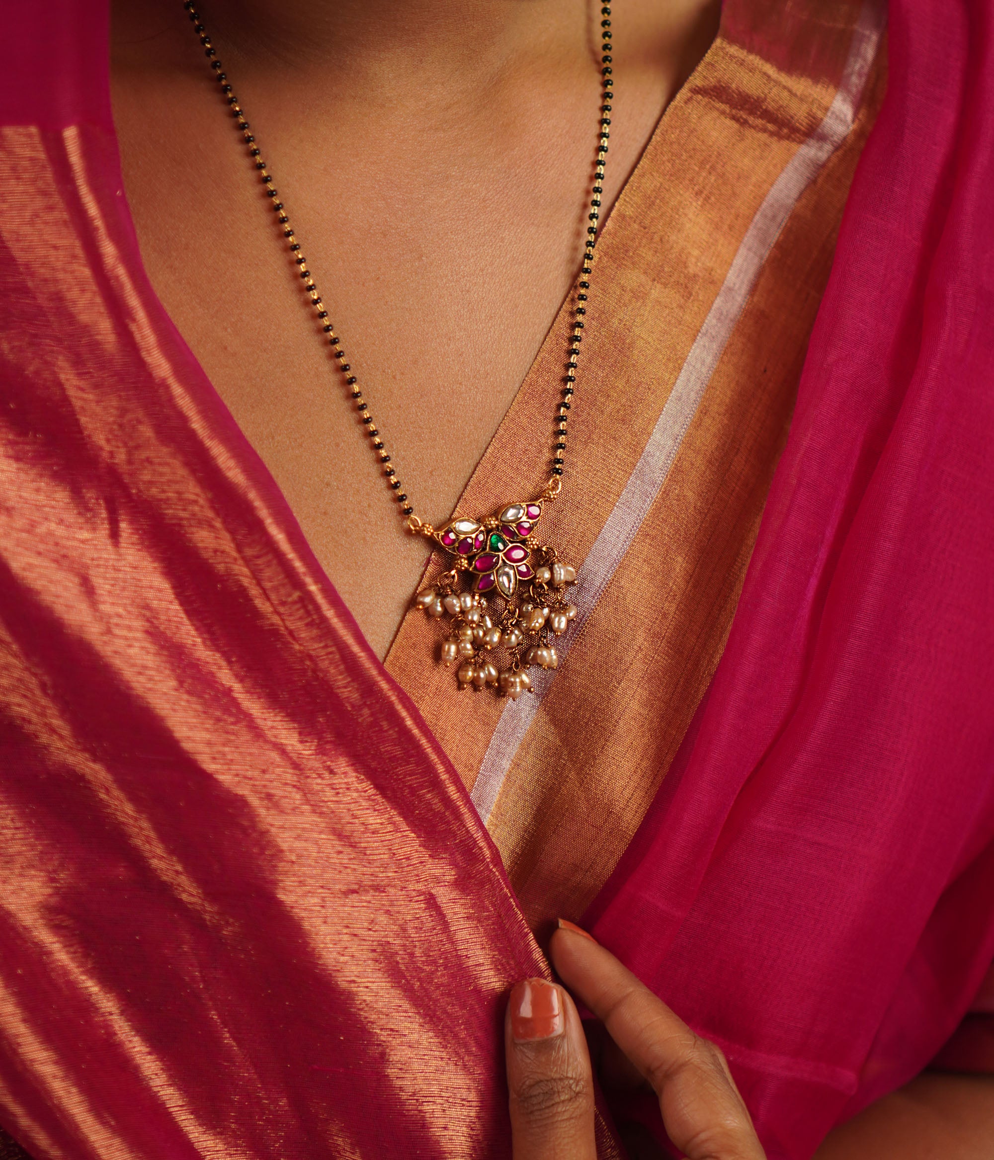 The Pansy Mangalsutra, crafted in gold-plated silver with radiant kundan stones and delicate pearl drops, seamlessly merges tradition with contemporary elegance. A timeless piece that celebrates heritage with a modern touch.