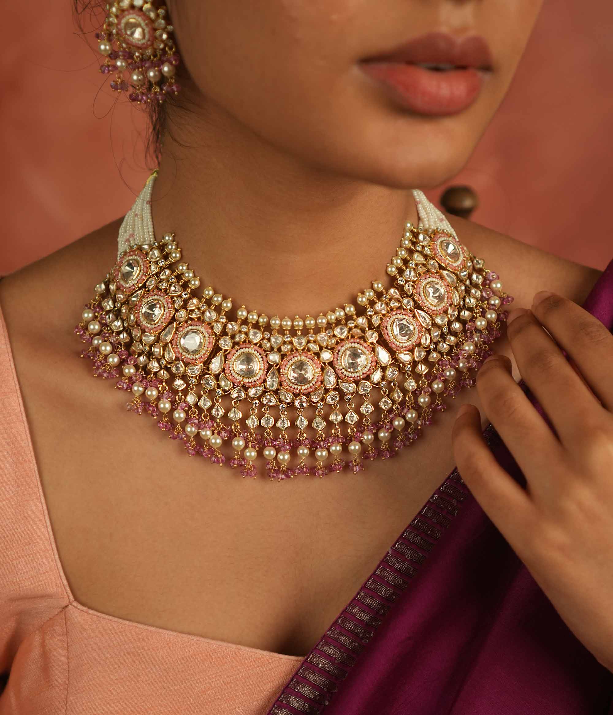 A regal masterpiece! This Moissanite Polki stone necklace, adorned with white pearls and pink beads, radiates timeless elegance. A statement of heritage and modern grace, perfect for the contemporary bride.