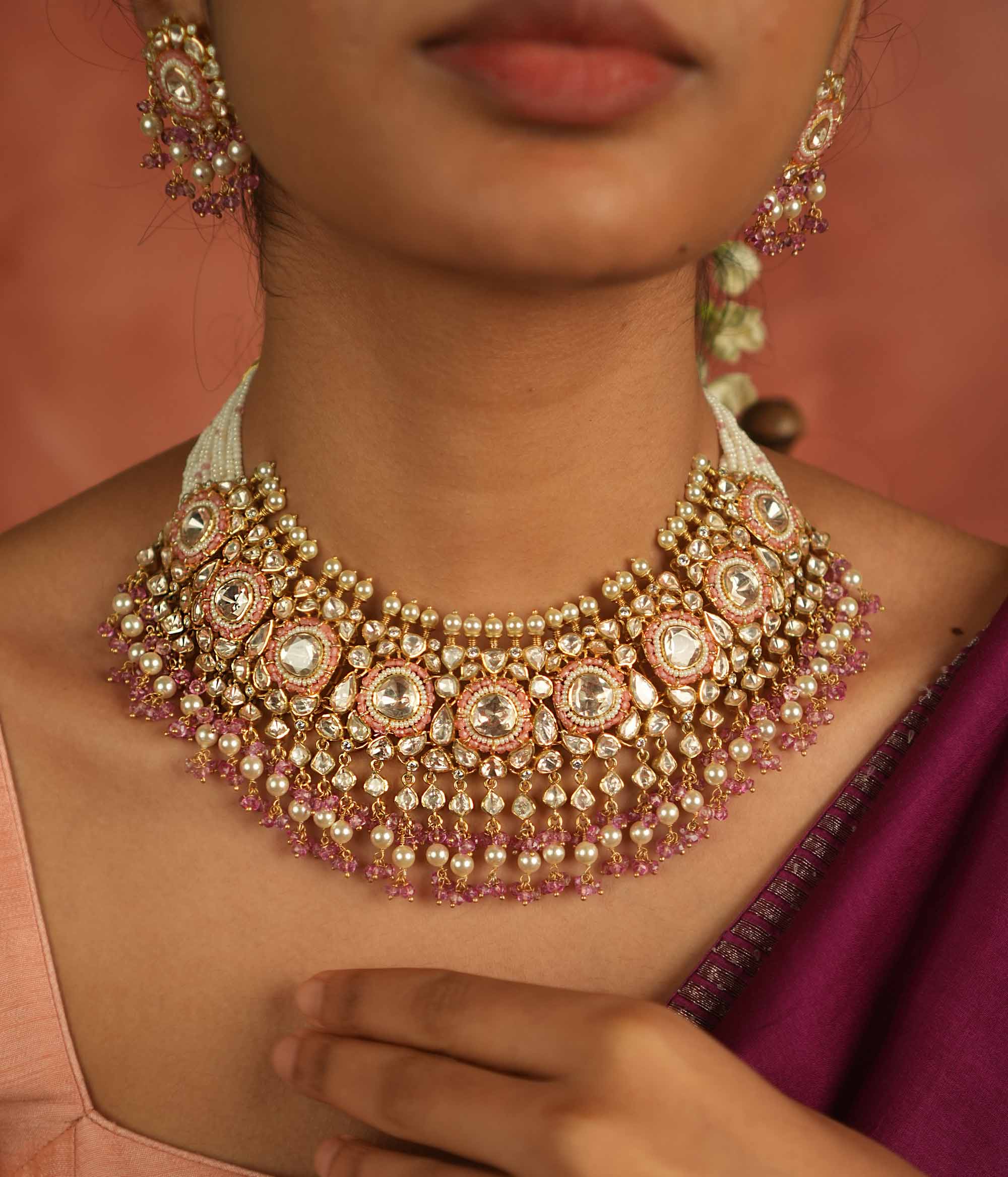 A regal masterpiece! This Moissanite Polki stone necklace, adorned with white pearls and pink beads, radiates timeless elegance. A statement of heritage and modern grace, perfect for the contemporary bride.