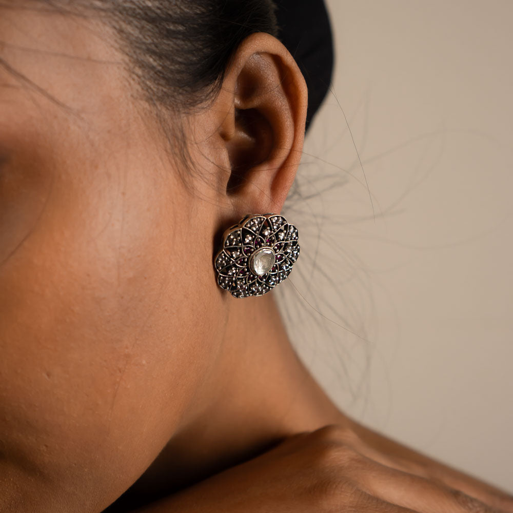 These stud earrings, crafted in oxidized silver, feature delicate gemstones at their heart, exuding timeless elegance with a contemporary touch.