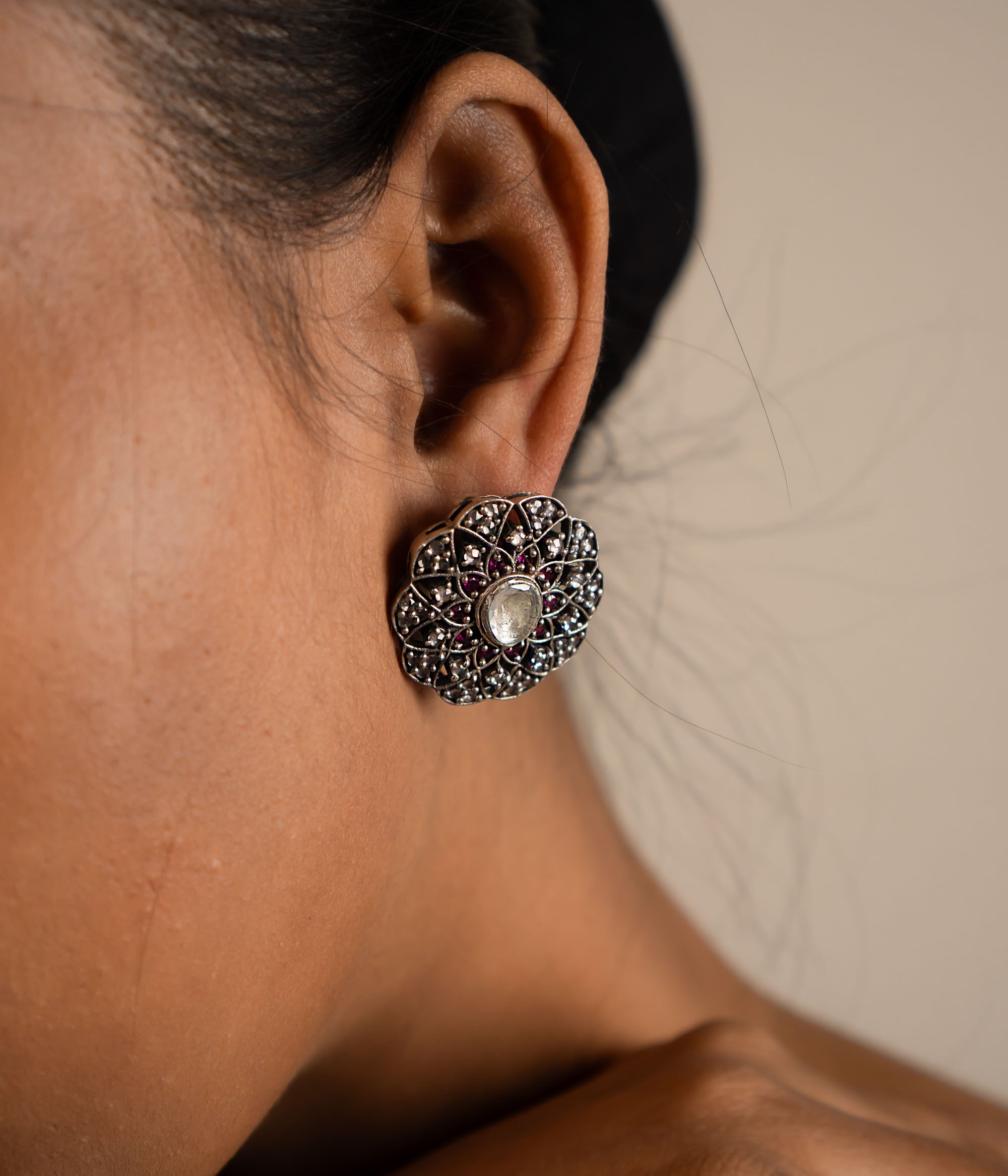 These stud earrings, crafted in oxidized silver, feature delicate gemstones at their heart, exuding timeless elegance with a contemporary touch.