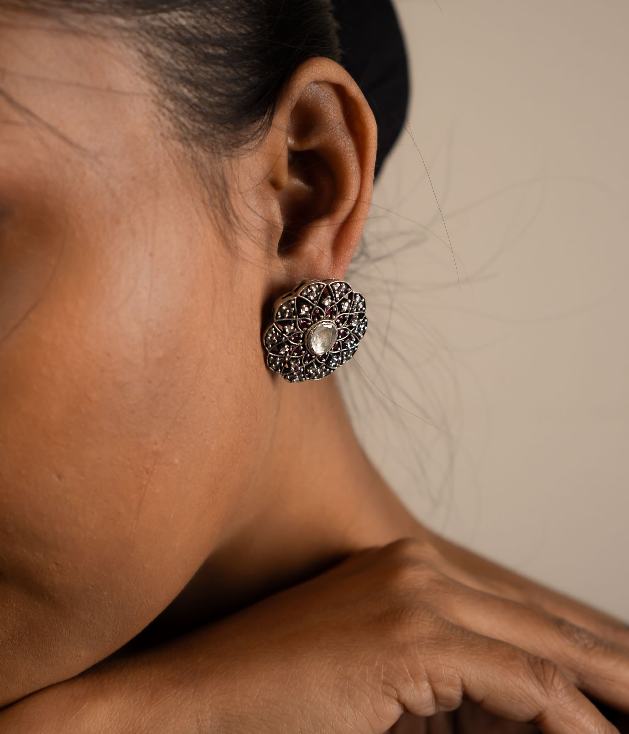 These stud earrings, crafted in oxidized silver, feature delicate gemstones at their heart, exuding timeless elegance with a contemporary touch.