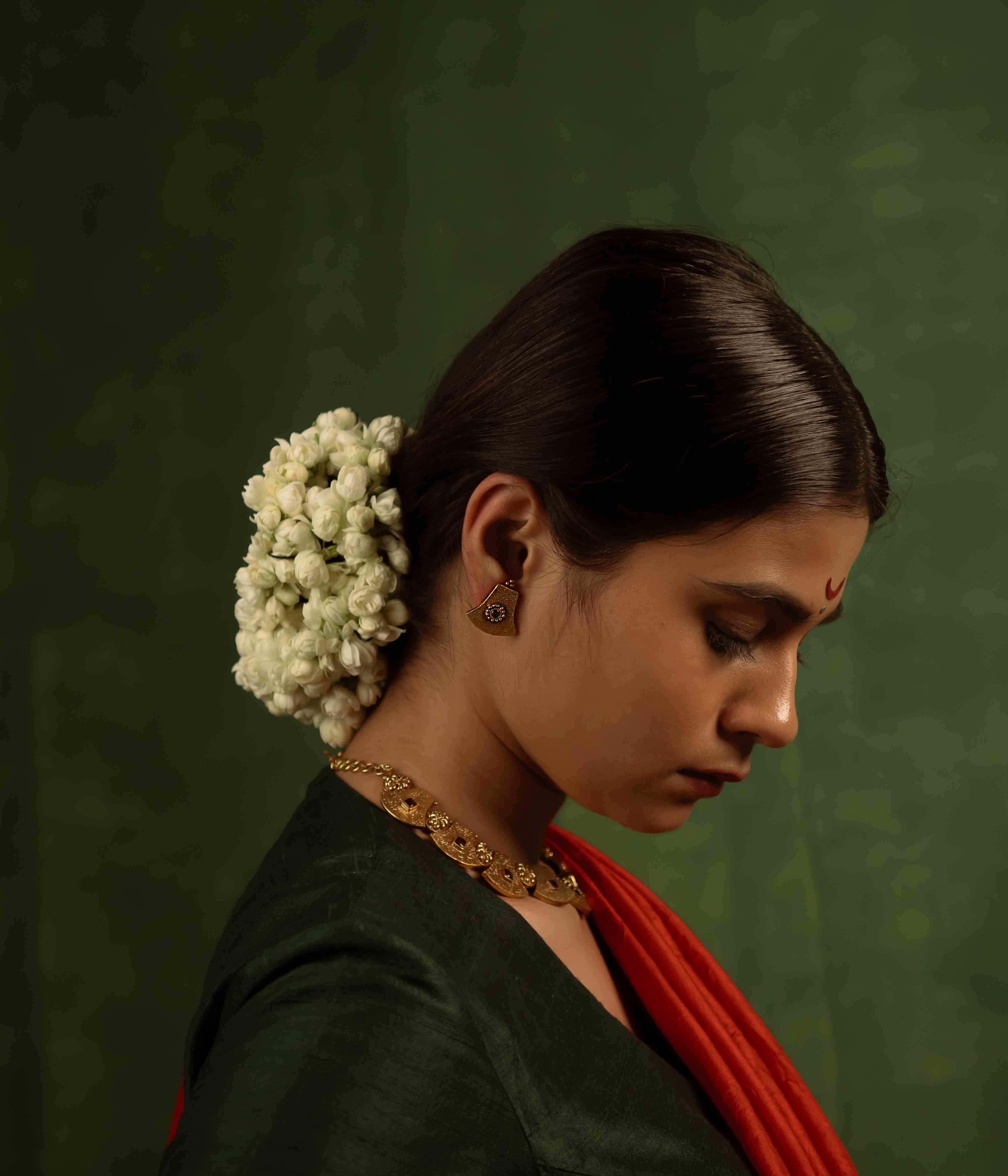 Ancient tales revived! The Peela-Kaner stud earrings (gold-plated silver) capture the essence of tribal heritage with their rich red spinel stones, delivering rustic elegance for the modern woman.