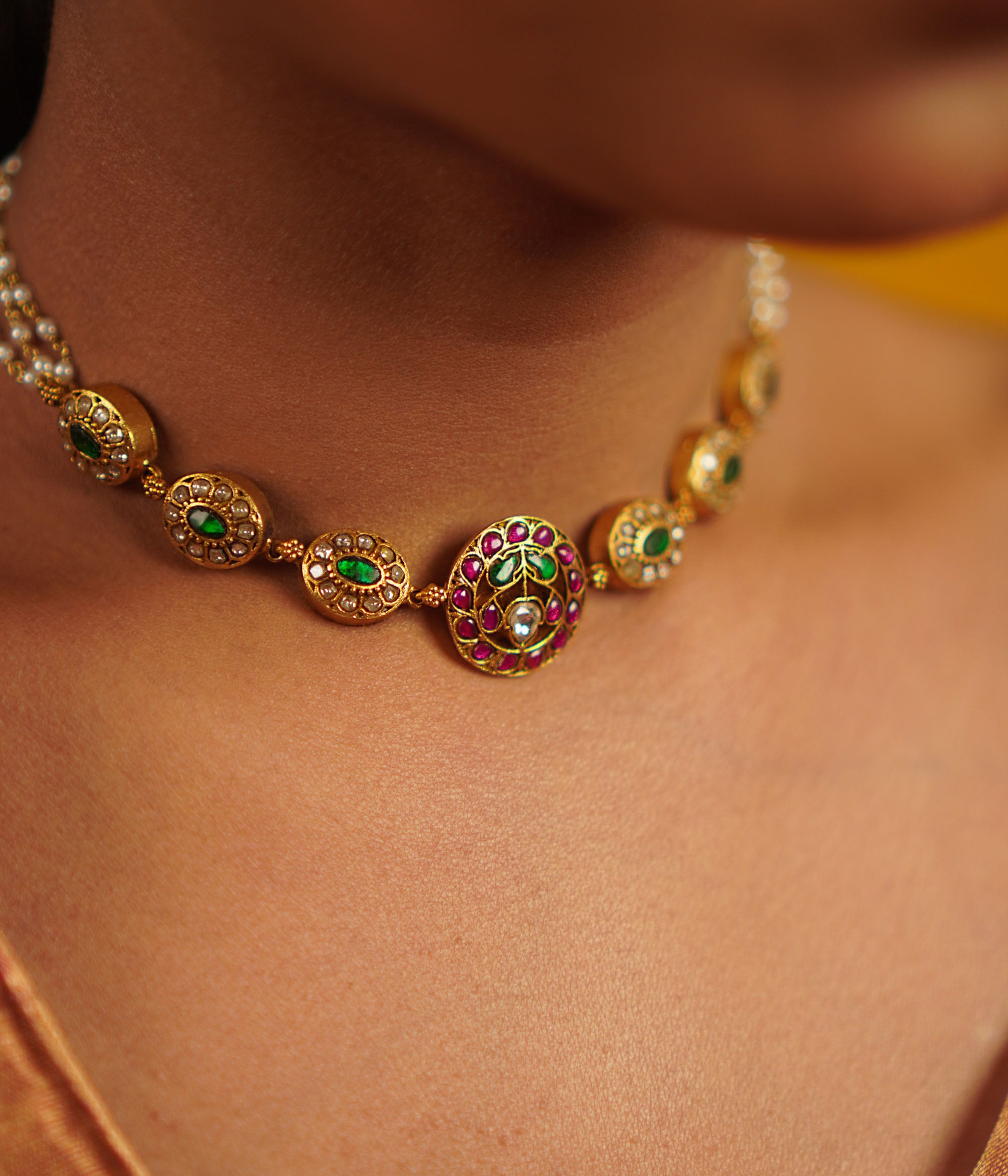 This antique silver choker, embellished with vibrant kundans, captures the delight of uncovering hidden treasures. A seamless fusion of tradition and charm, this piece embodies timeless elegance.