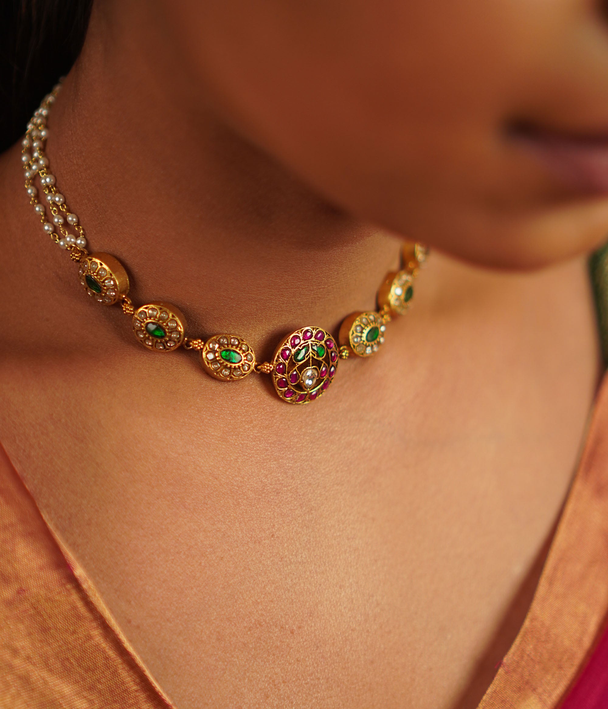 This antique silver choker, embellished with vibrant kundans, captures the delight of uncovering hidden treasures. A seamless fusion of tradition and charm, this piece embodies timeless elegance.