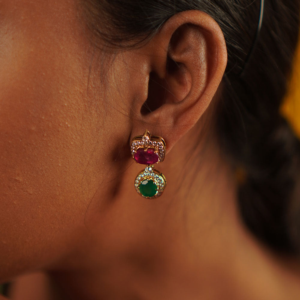Handcrafted in gold-plated silver, these butterfly-pea drop earrings shimmer with simulated rubies, emeralds, and CZ stones, radiating elegance and charm.