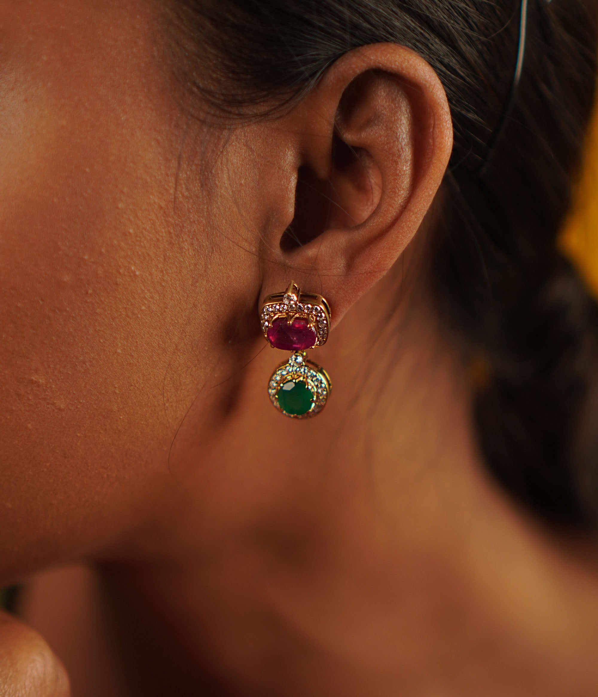 Handcrafted in gold-plated silver, these butterfly-pea drop earrings shimmer with simulated rubies, emeralds, and CZ stones, radiating elegance and charm.