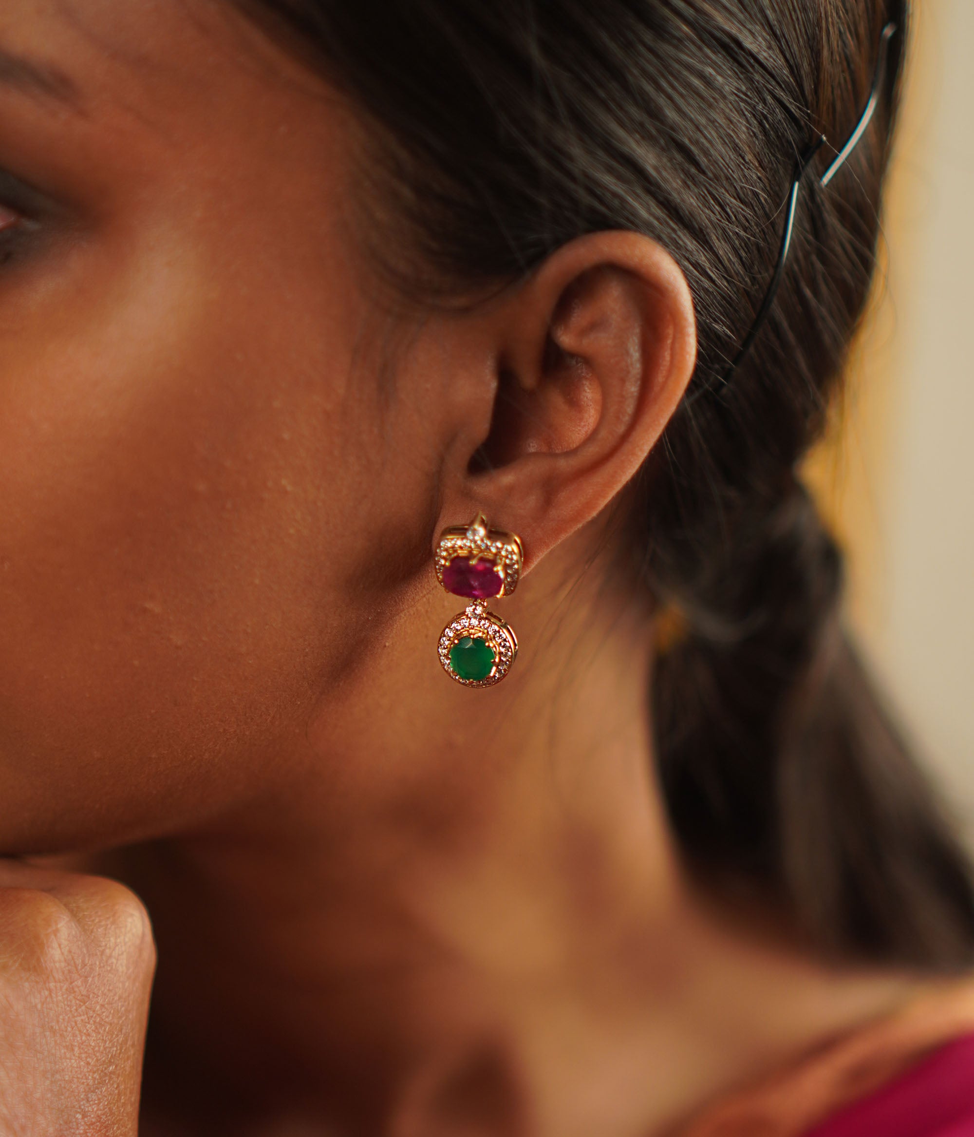 Handcrafted in gold-plated silver, these butterfly-pea drop earrings shimmer with simulated rubies, emeralds, and CZ stones, radiating elegance and charm.