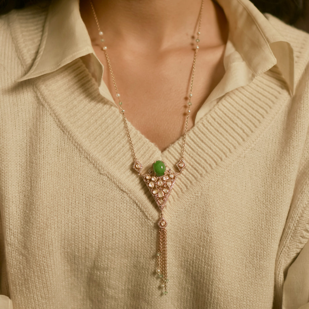 Triangular polki pendant chain with green gemstone, pearls, CZ accents, and tassel drop design.