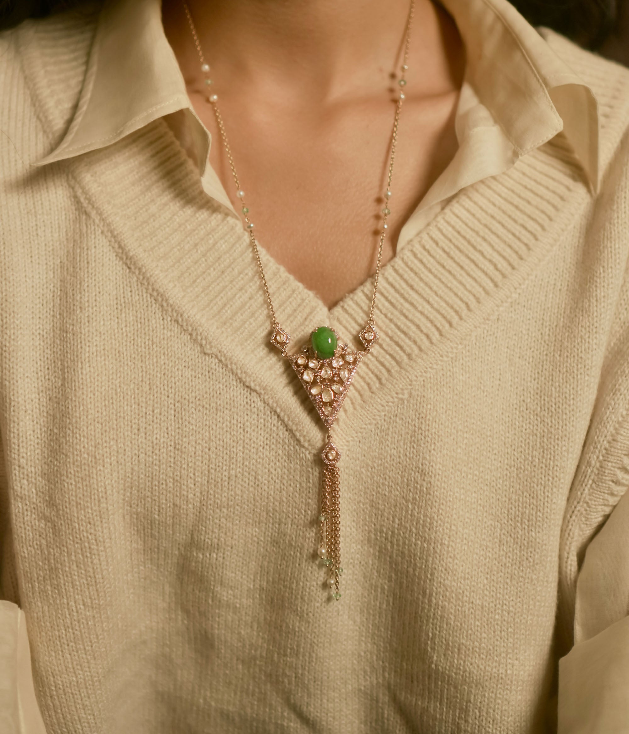 Triangular polki pendant chain with green gemstone, pearls, CZ accents, and tassel drop design.
