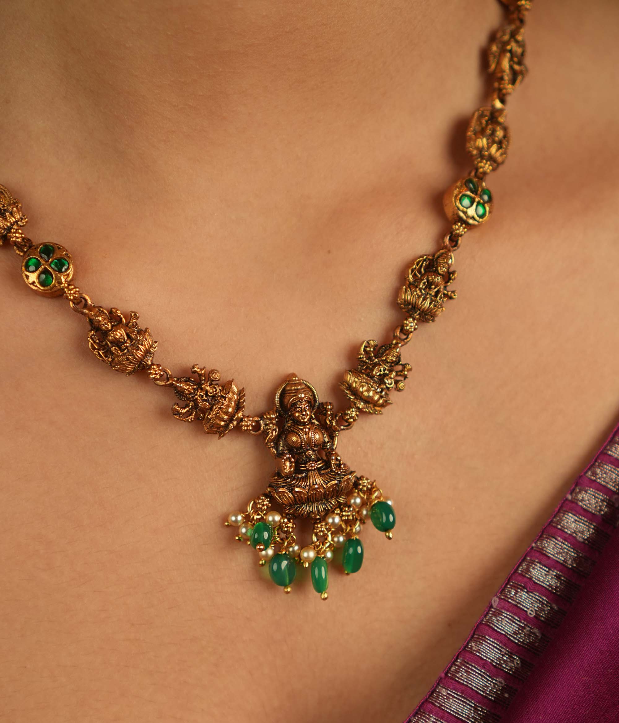 Sacred elegance revived! This antique Lakshmi necklace, crafted in gold-plated silver, radiates prosperity with luminous green Kundan stones and delicate green bead droplets—a timeless tribute to tradition.