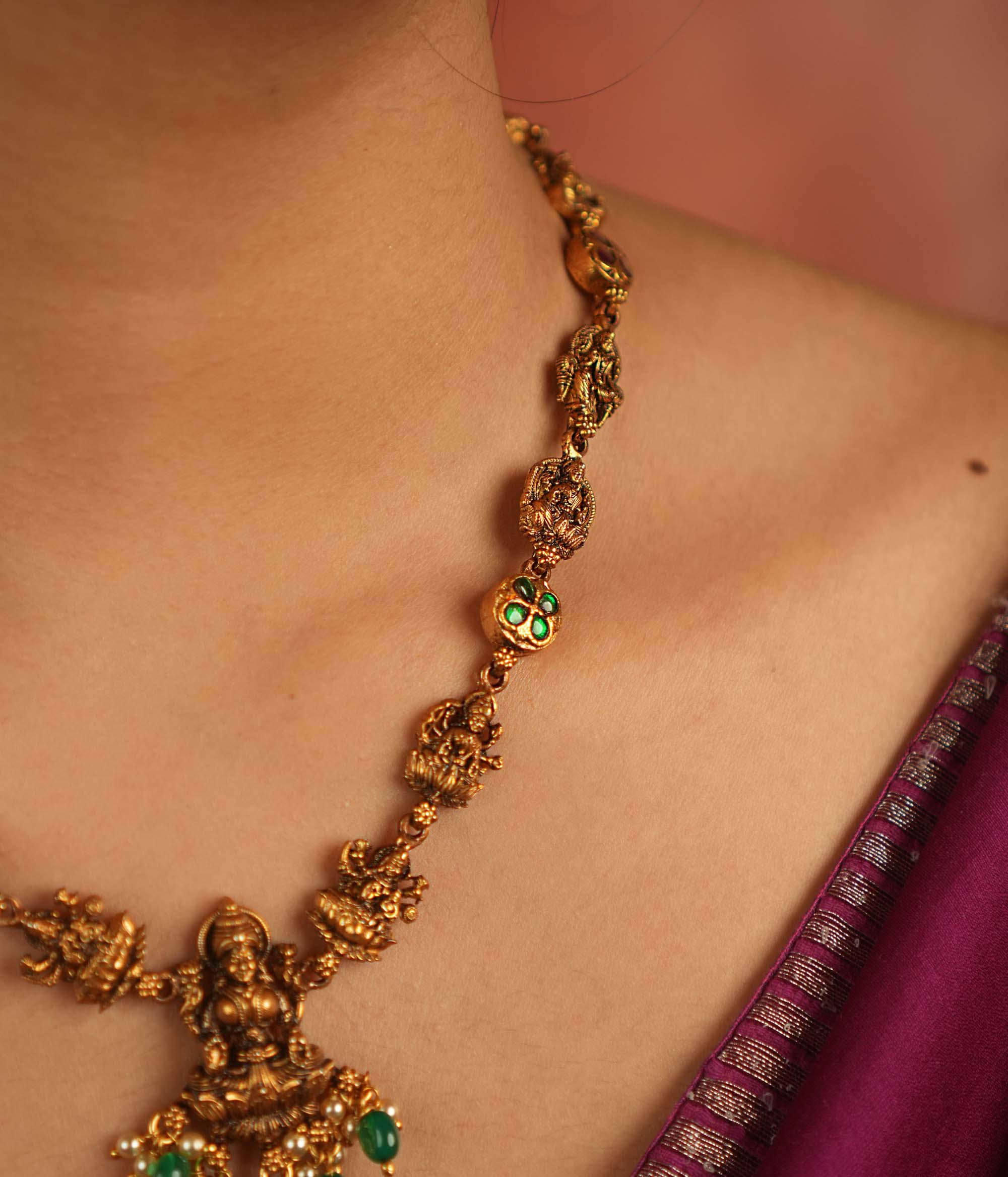 Sacred elegance revived! This antique Lakshmi necklace, crafted in gold-plated silver, radiates prosperity with luminous green Kundan stones and delicate green bead droplets—a timeless tribute to tradition.