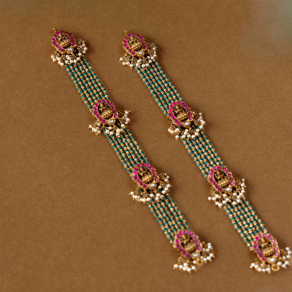 Elegant temple-style beaded chain featuring 92.5 sterling silver, 22k gold plating, red and white Kundan stones, and pearls.