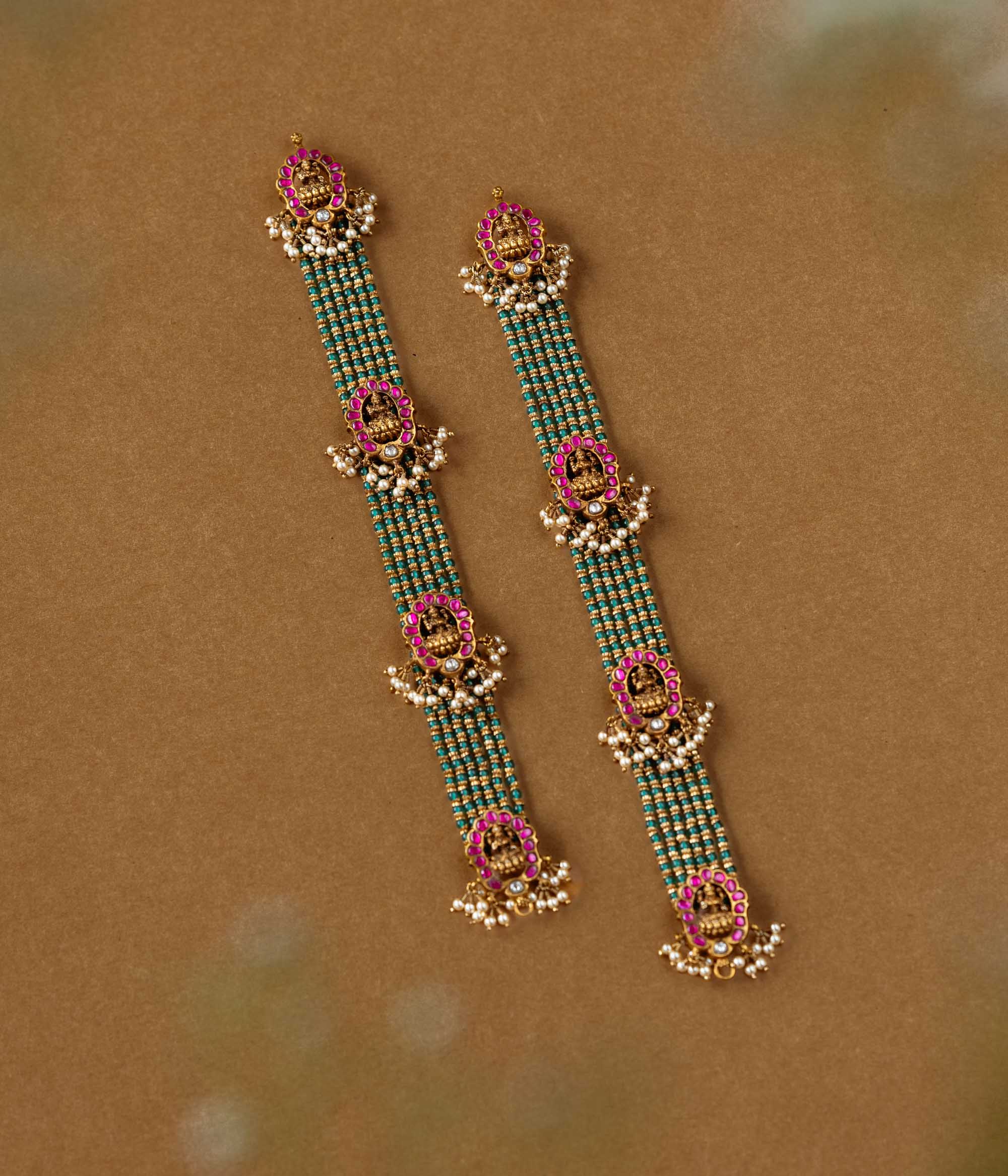 Elegant temple-style beaded chain featuring 92.5 sterling silver, 22k gold plating, red and white Kundan stones, and pearls.