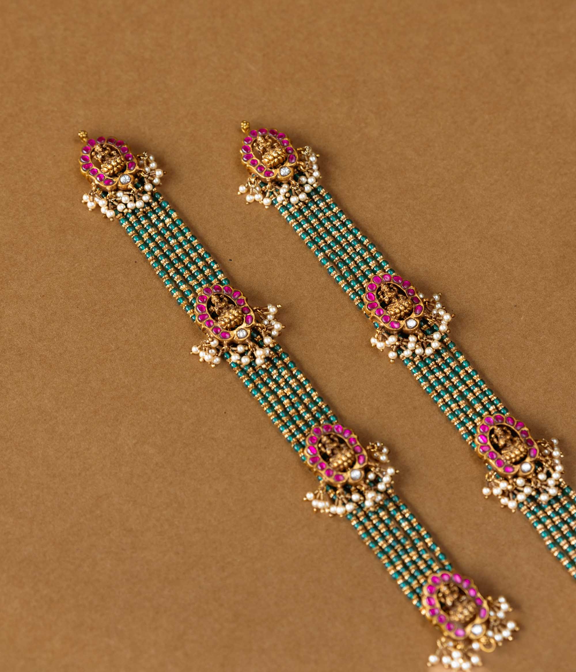 Elegant temple-style beaded chain featuring 92.5 sterling silver, 22k gold plating, red and white Kundan stones, and pearls.