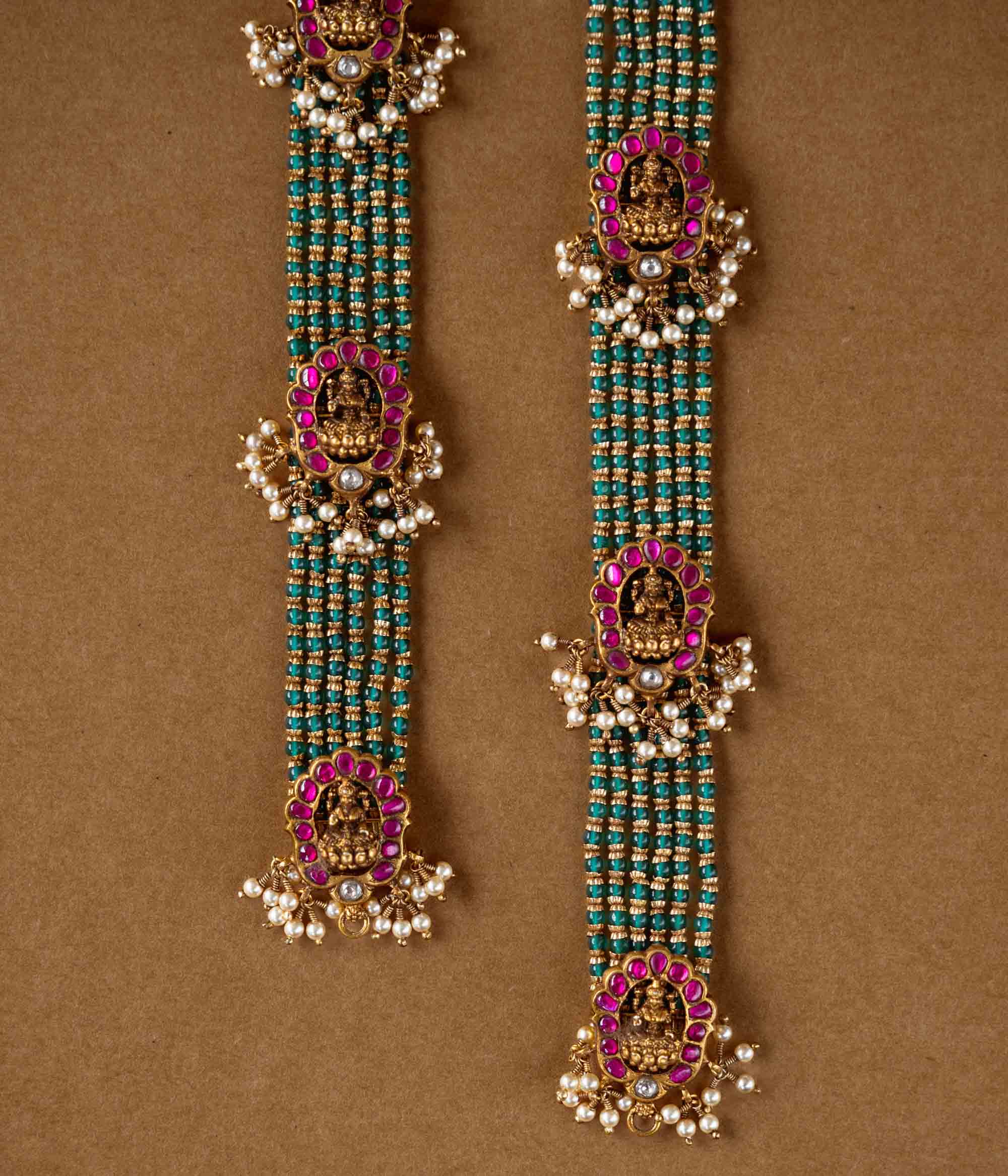Elegant temple-style beaded chain featuring 92.5 sterling silver, 22k gold plating, red and white Kundan stones, and pearls.