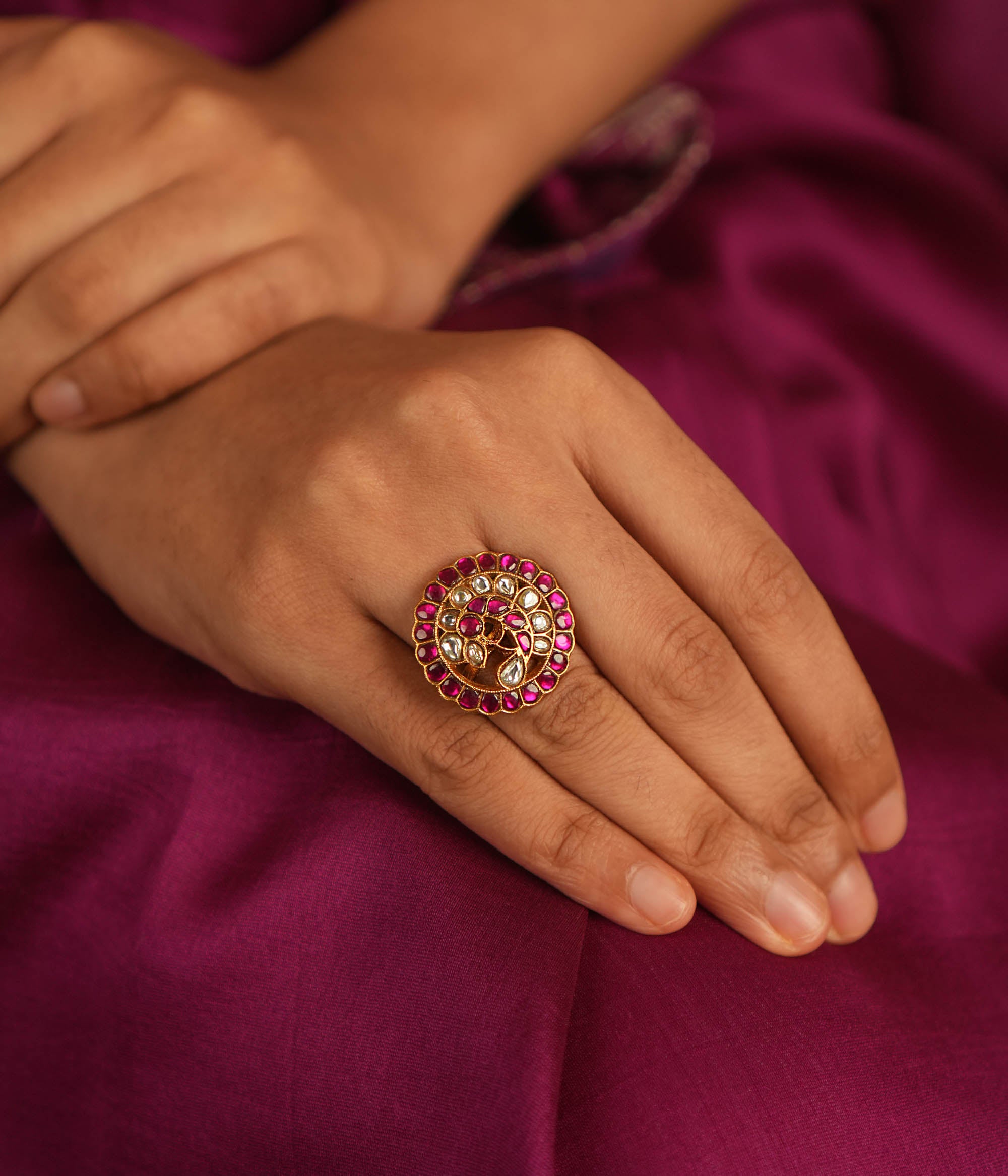 Winged elegance! This bird-shaped Kundan ring shimmers with red and white stones, capturing the beauty of nature in a dazzling embrace.