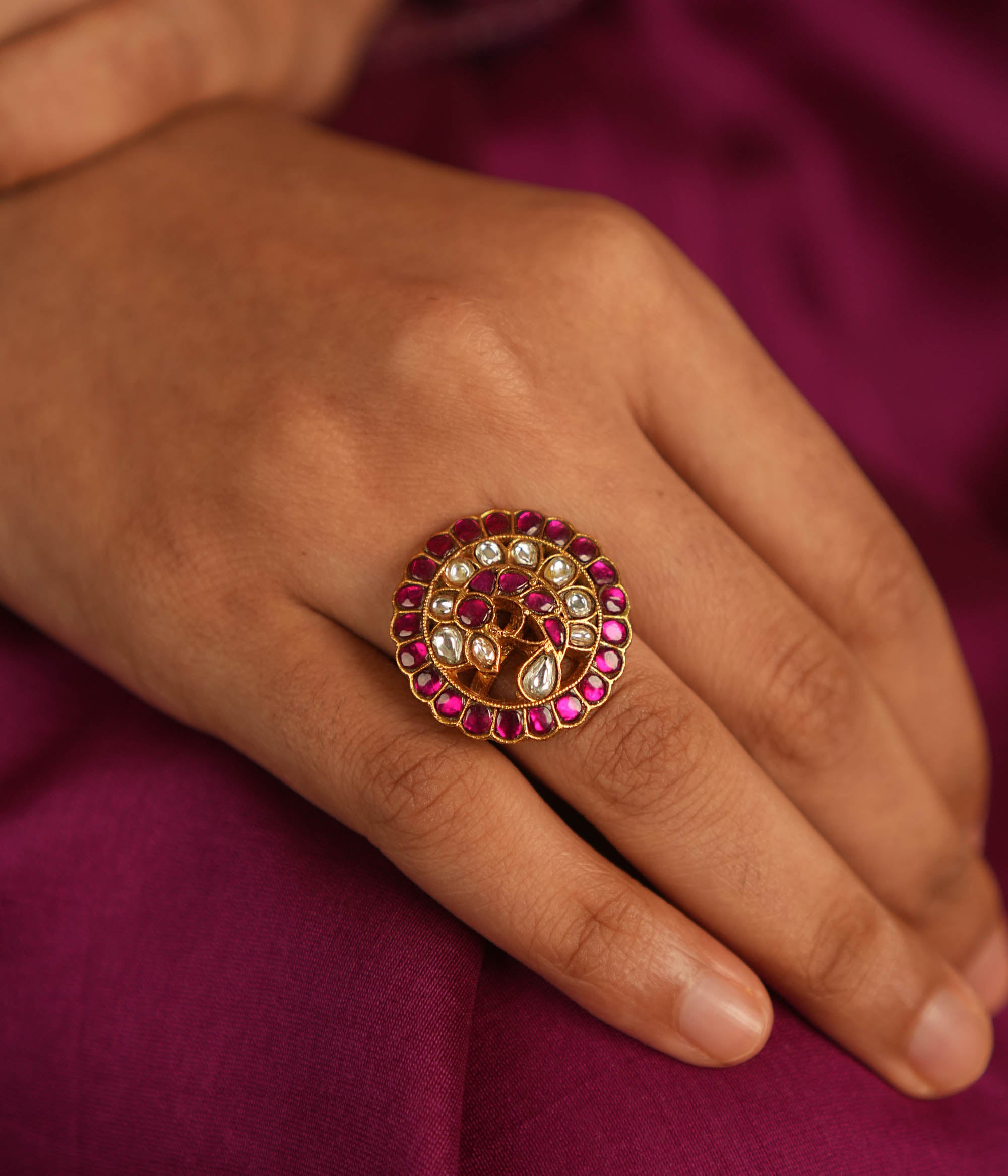 Winged elegance! This bird-shaped Kundan ring shimmers with red and white stones, capturing the beauty of nature in a dazzling embrace.