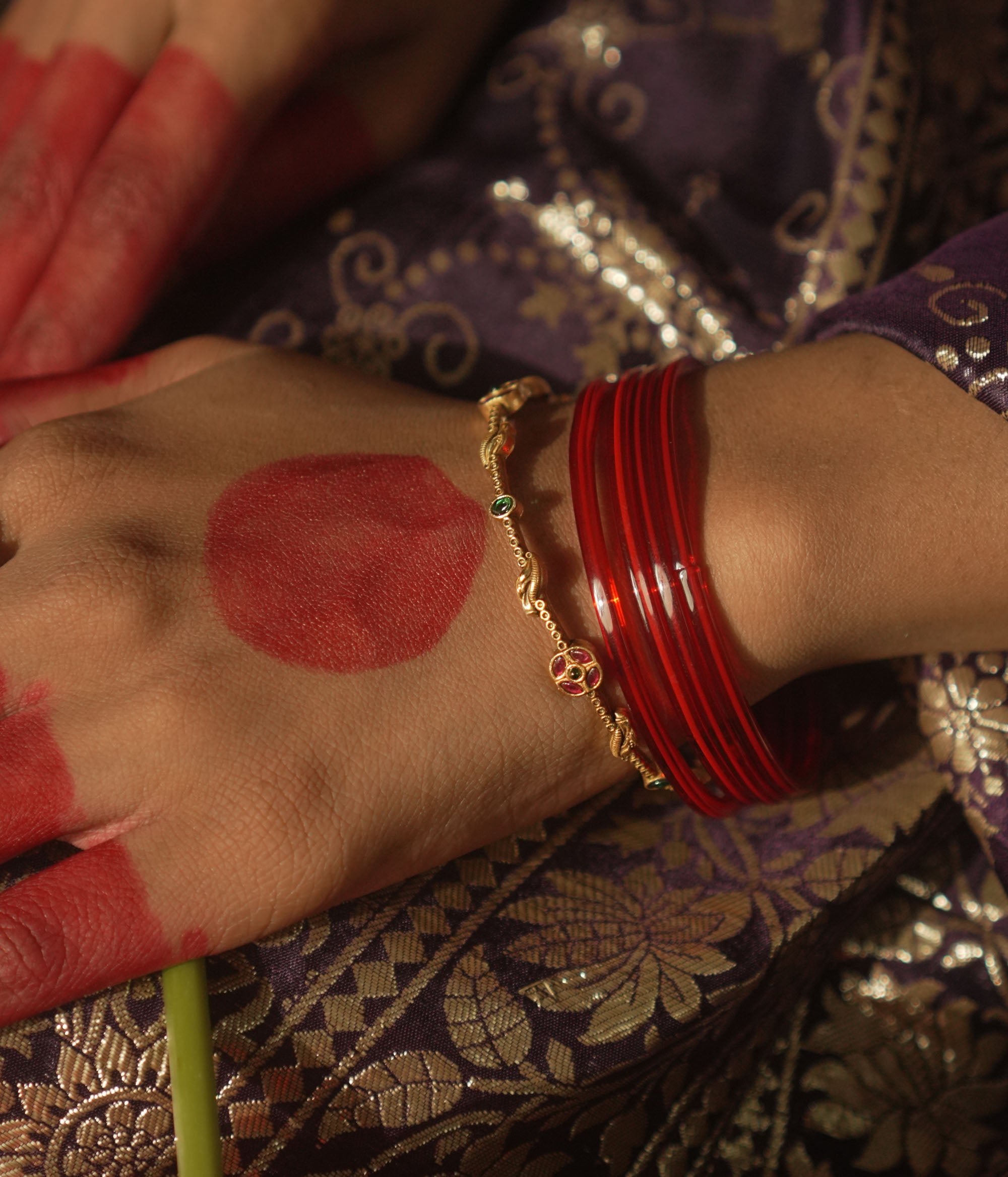Gold-plated silver bangle with scattered gemstones.
