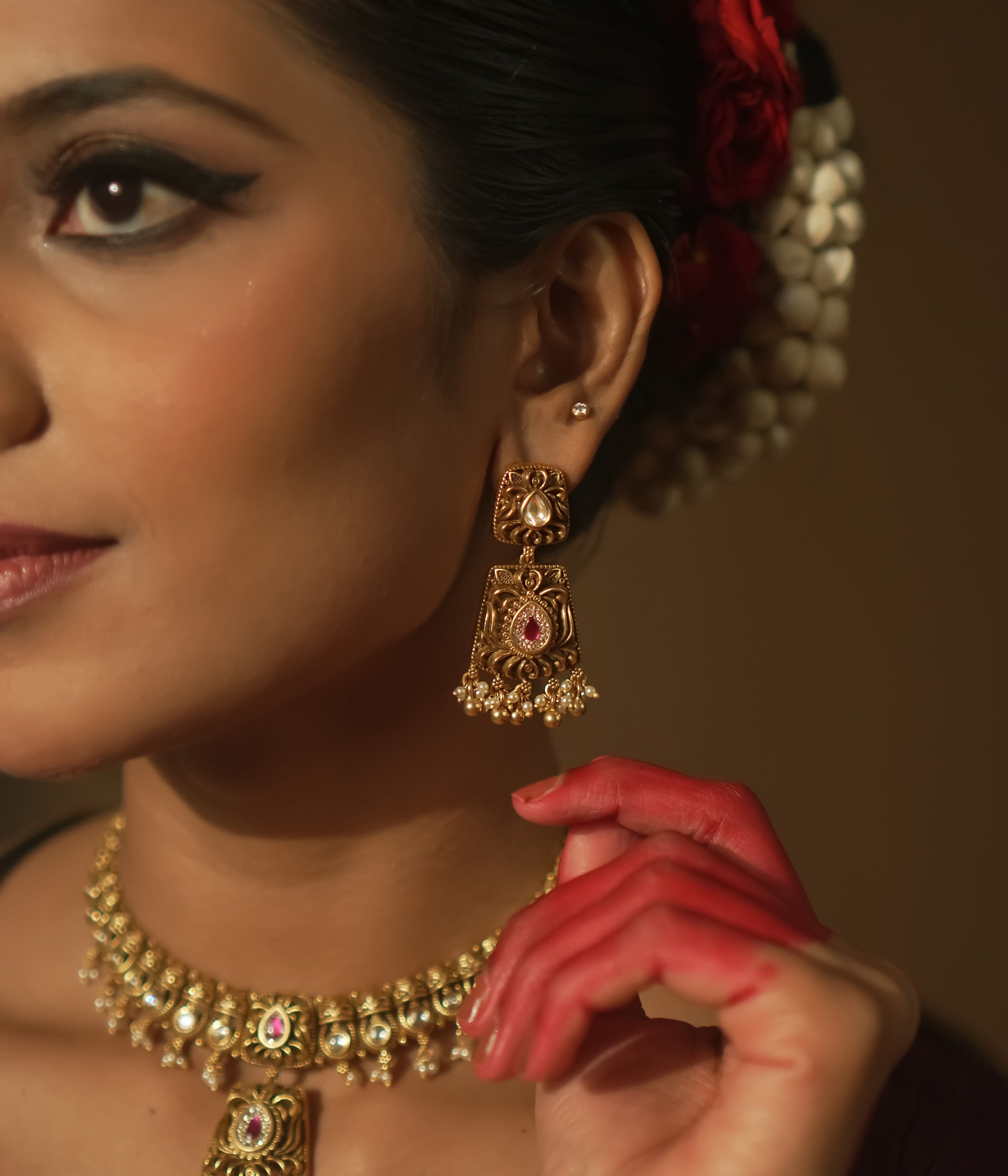 Intricate filigree earrings with teardrop gems, red stones, and pearls.