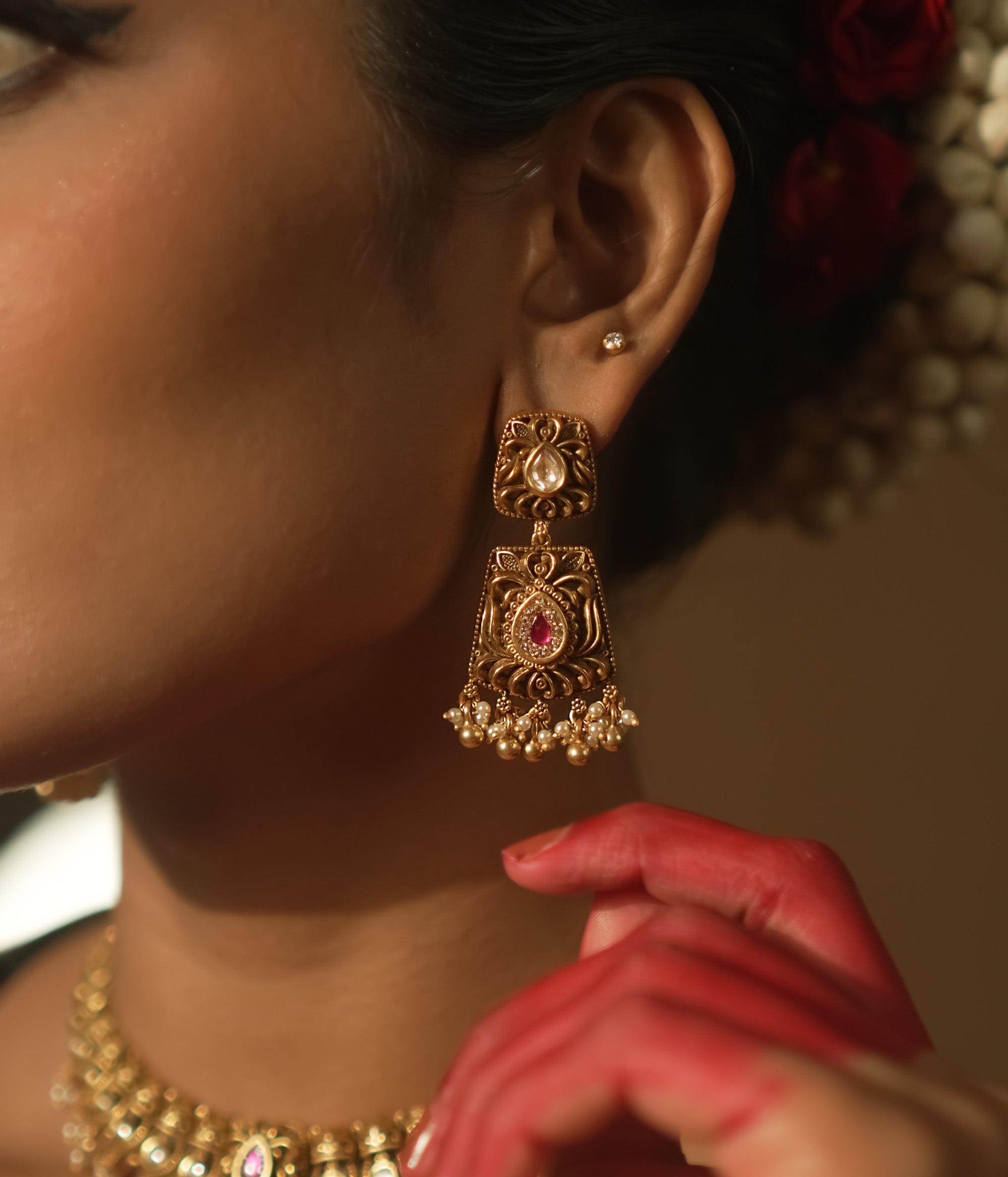 Intricate filigree earrings with teardrop gems, red stones, and pearls.