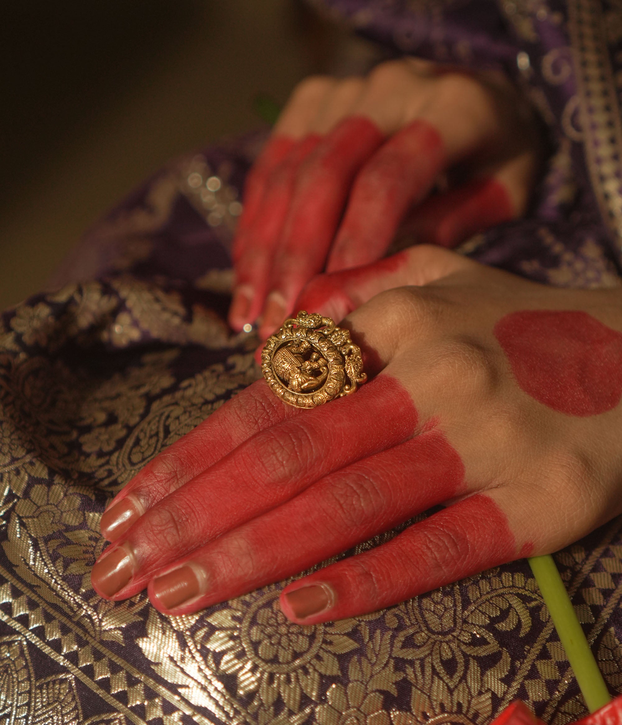 Gold ring with a central gaja (elephant) motif and swirling patterns.