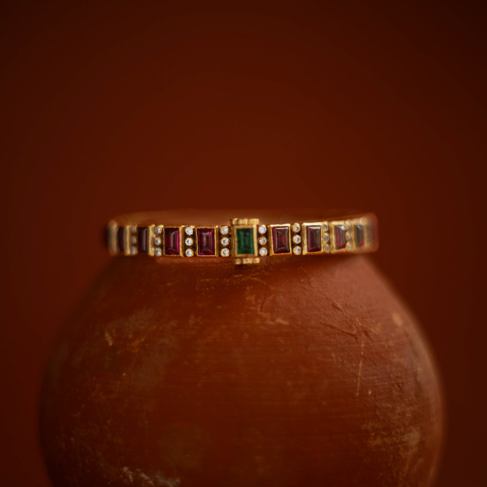 Slim gold bangle with red, green cut stones and CZ accents from Stone collection.