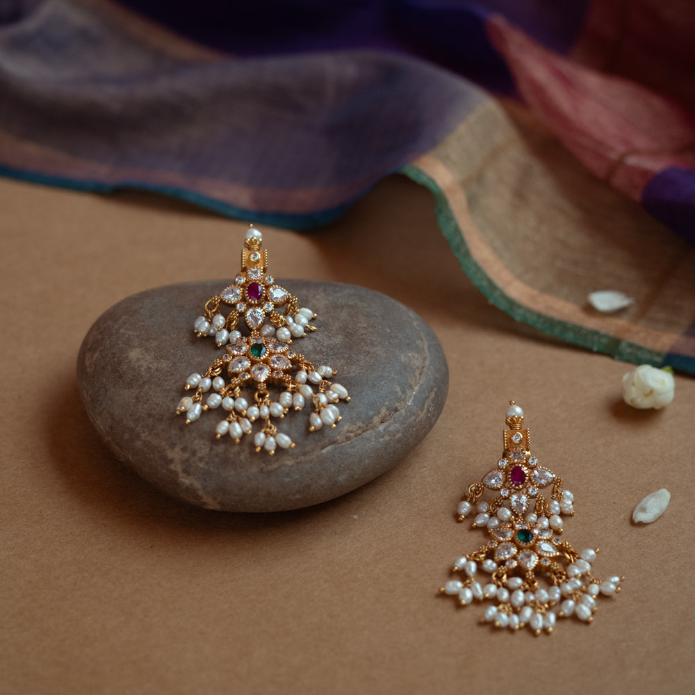 Gold drop earrings with a cluster of red, green, white cut stones, Swarovski stones, and multiple dangling pearls.