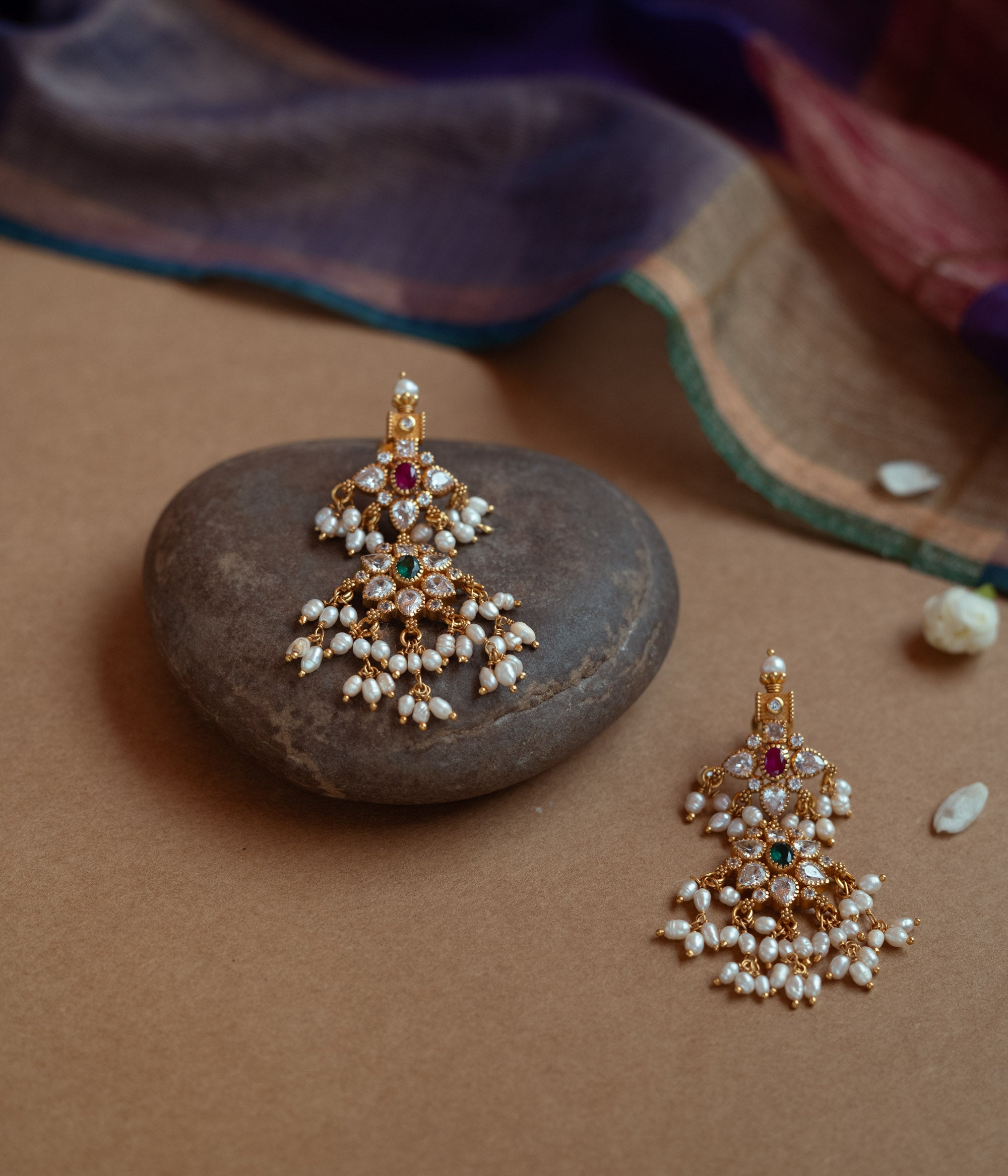 Gold drop earrings with a cluster of red, green, white cut stones, Swarovski stones, and multiple dangling pearls.